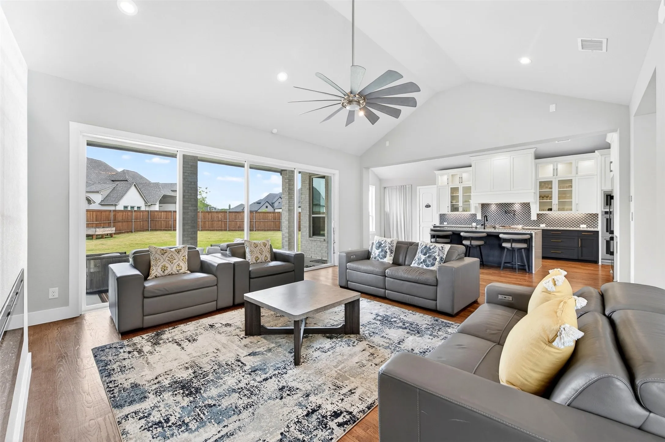 Vaulted ceilings with a ceiling fan and recessed lighting
