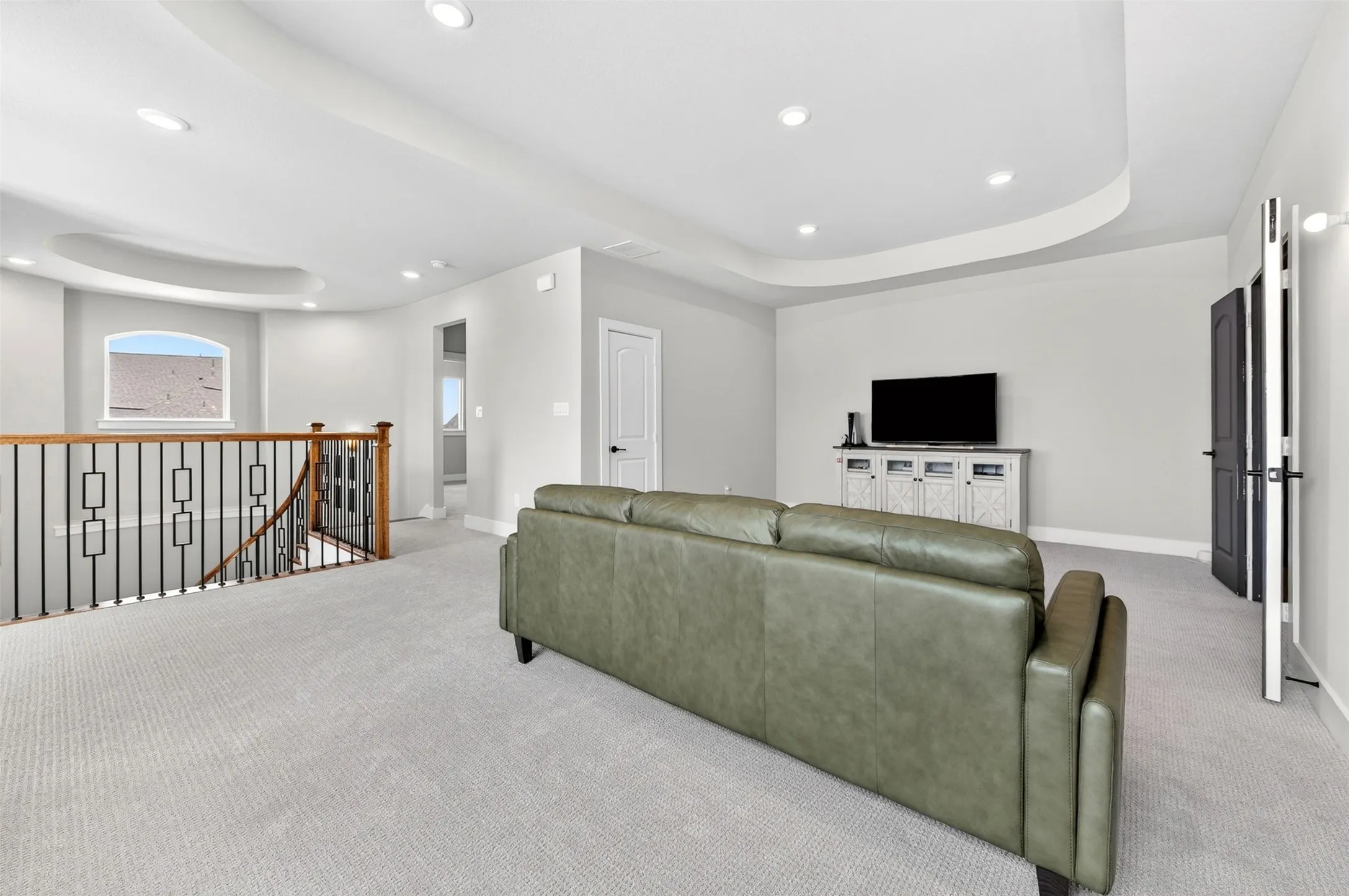 Spacious bonus room featuring recessed lighting, a tray ceiling, and carpeted flooring