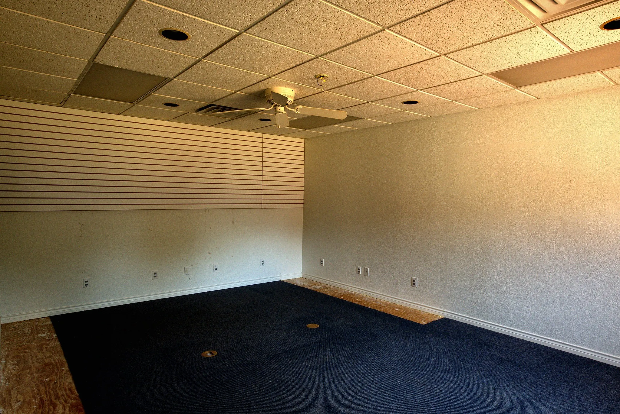 Suspended acoustic tile ceiling with recessed lighting and a ceiling fan