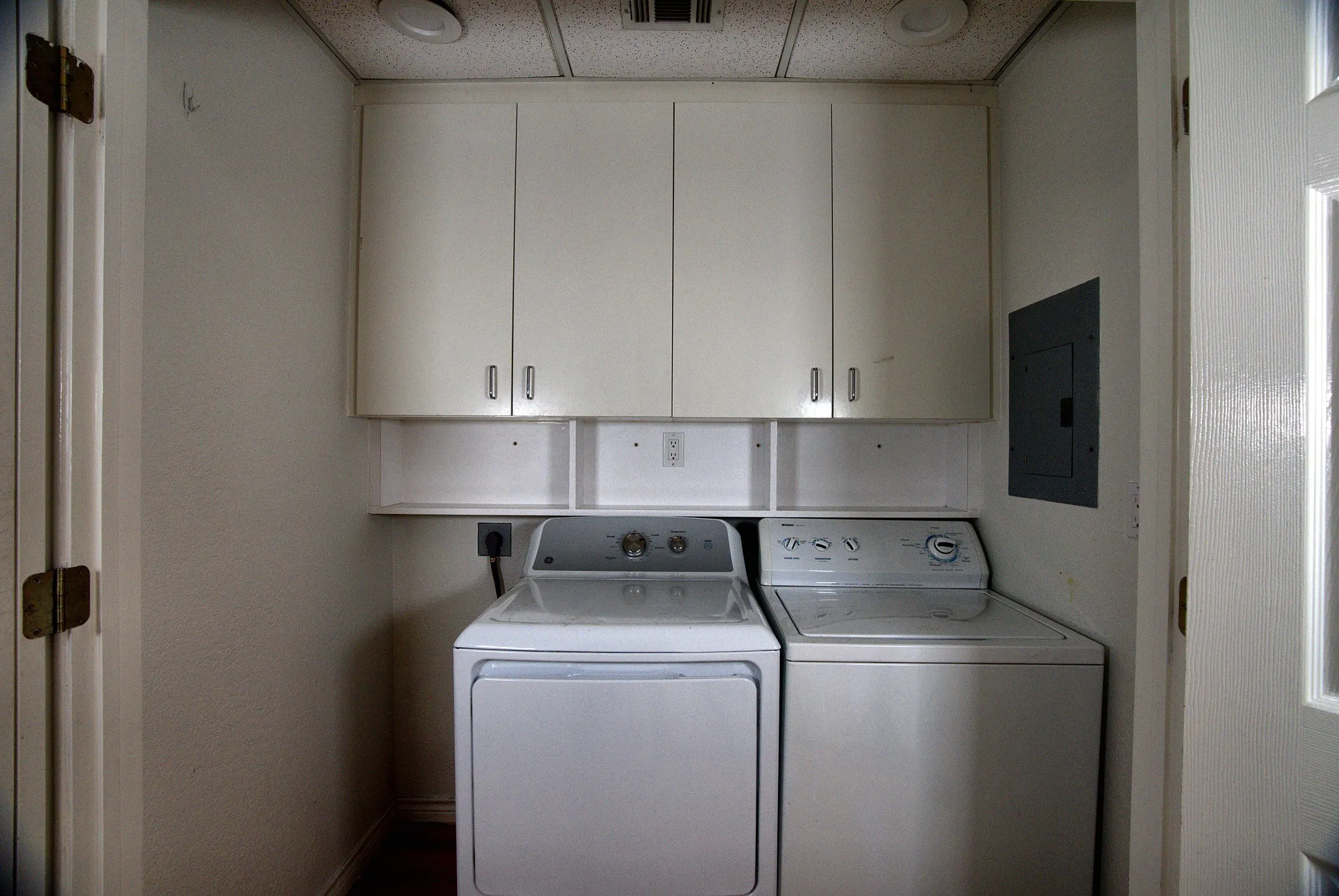 Built-in white cabinetry, integrated shelving, and recessed lighting
