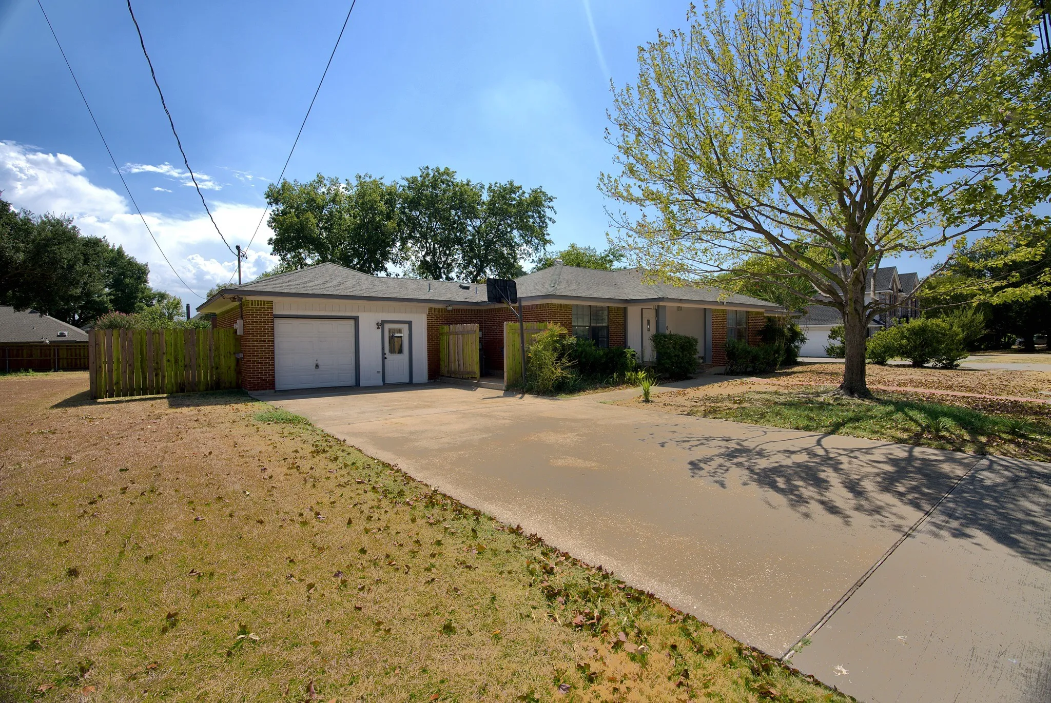 Brick exterior with a single-car garage and an extended driveway