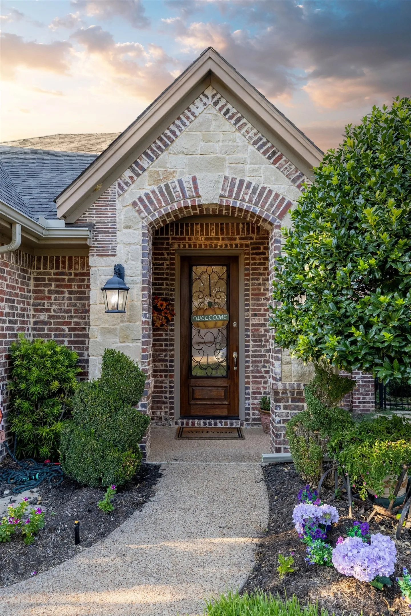 Brick and stone facade with an arched entry