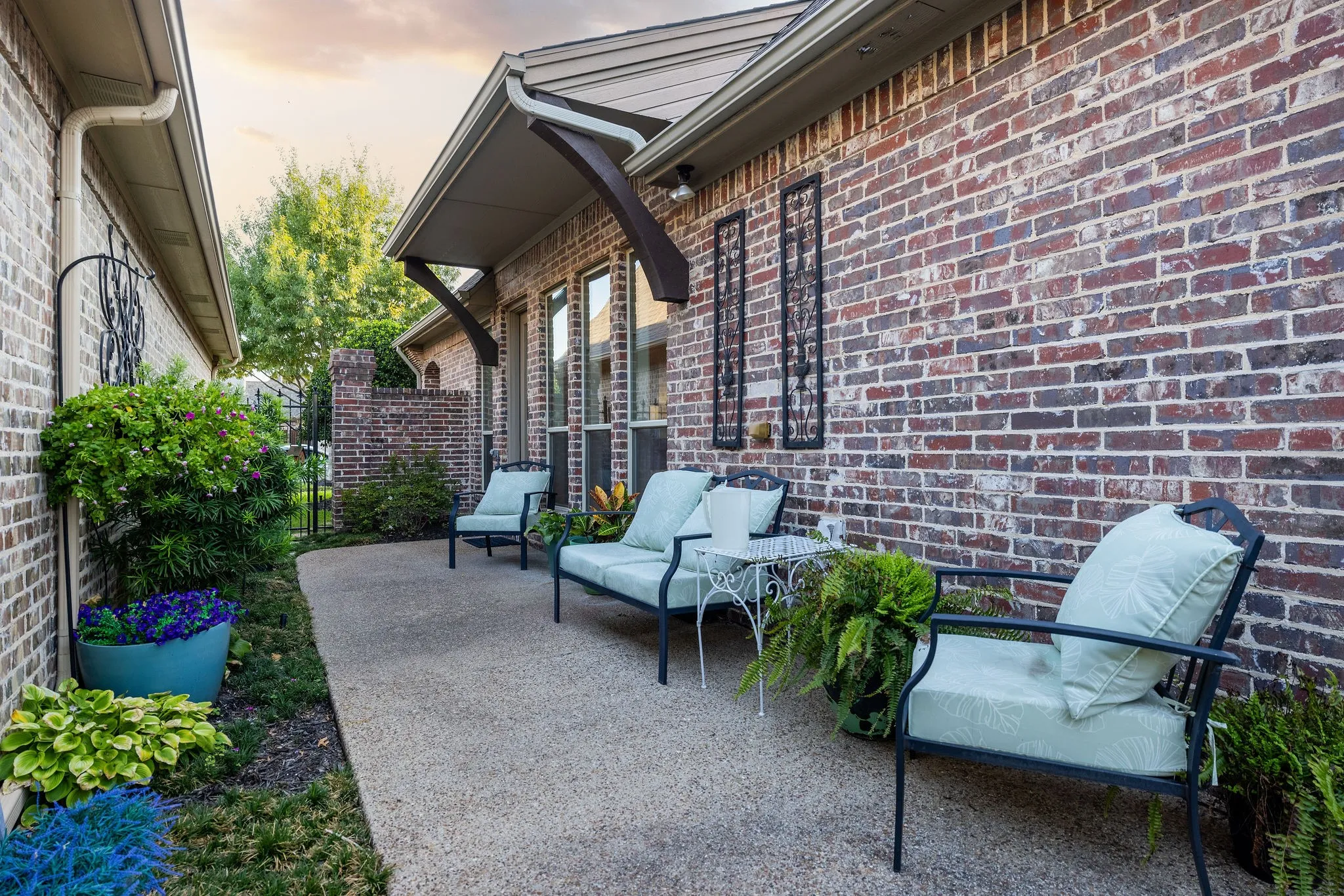 Exposed aggregate patio with brick exterior and recessed windows
