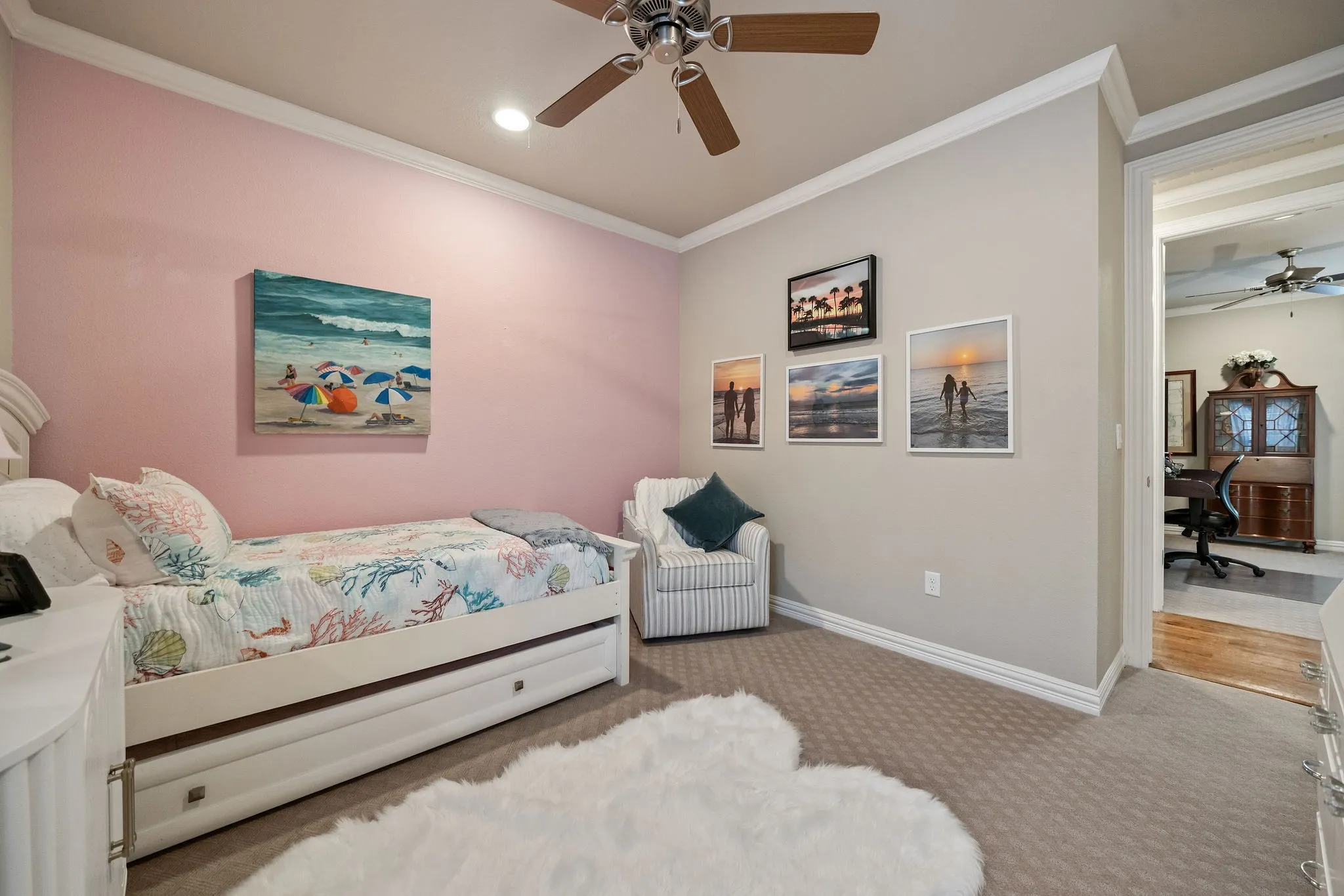 Recessed lighting, crown molding, and a ceiling fan with wood-finish blades