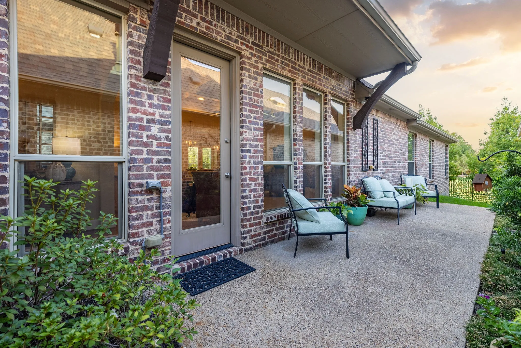 Brick exterior with multiple windows and a glass-paneled door