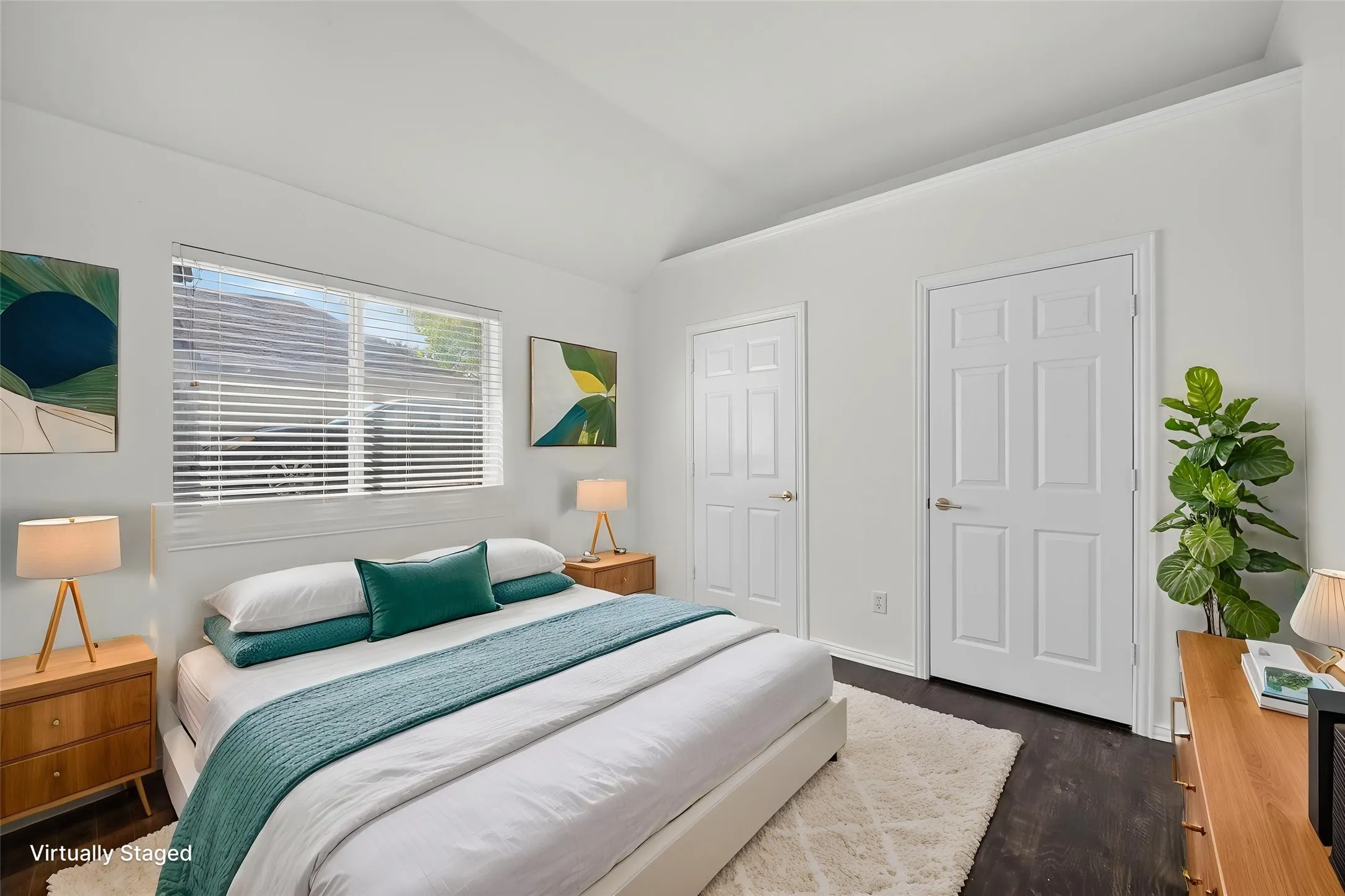 Vaulted ceiling, recessed window with blinds, dark wood-finish flooring, and white paneled doors