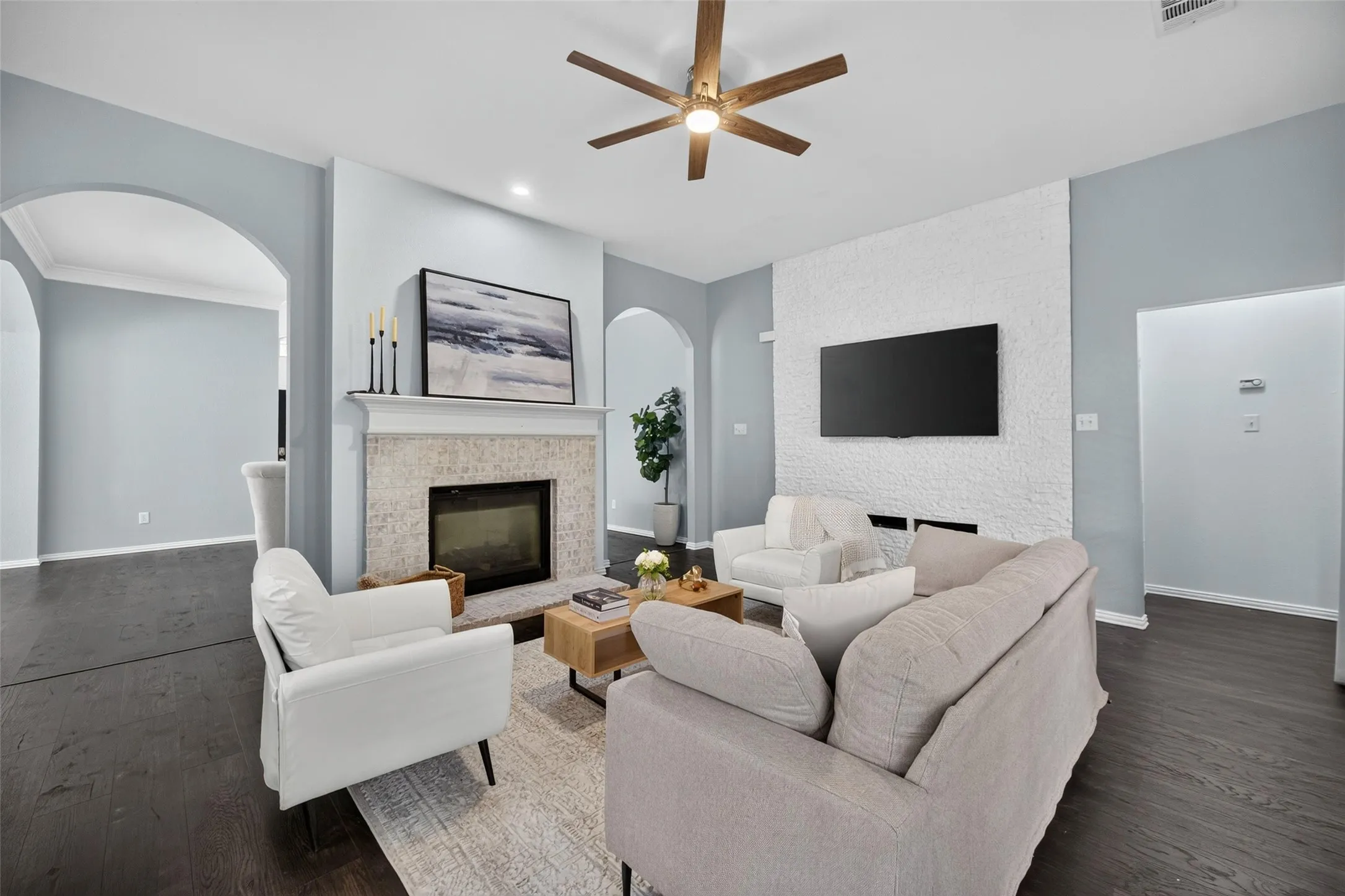 Wood-finish flooring, recessed lighting, and a ceiling fan with integrated light