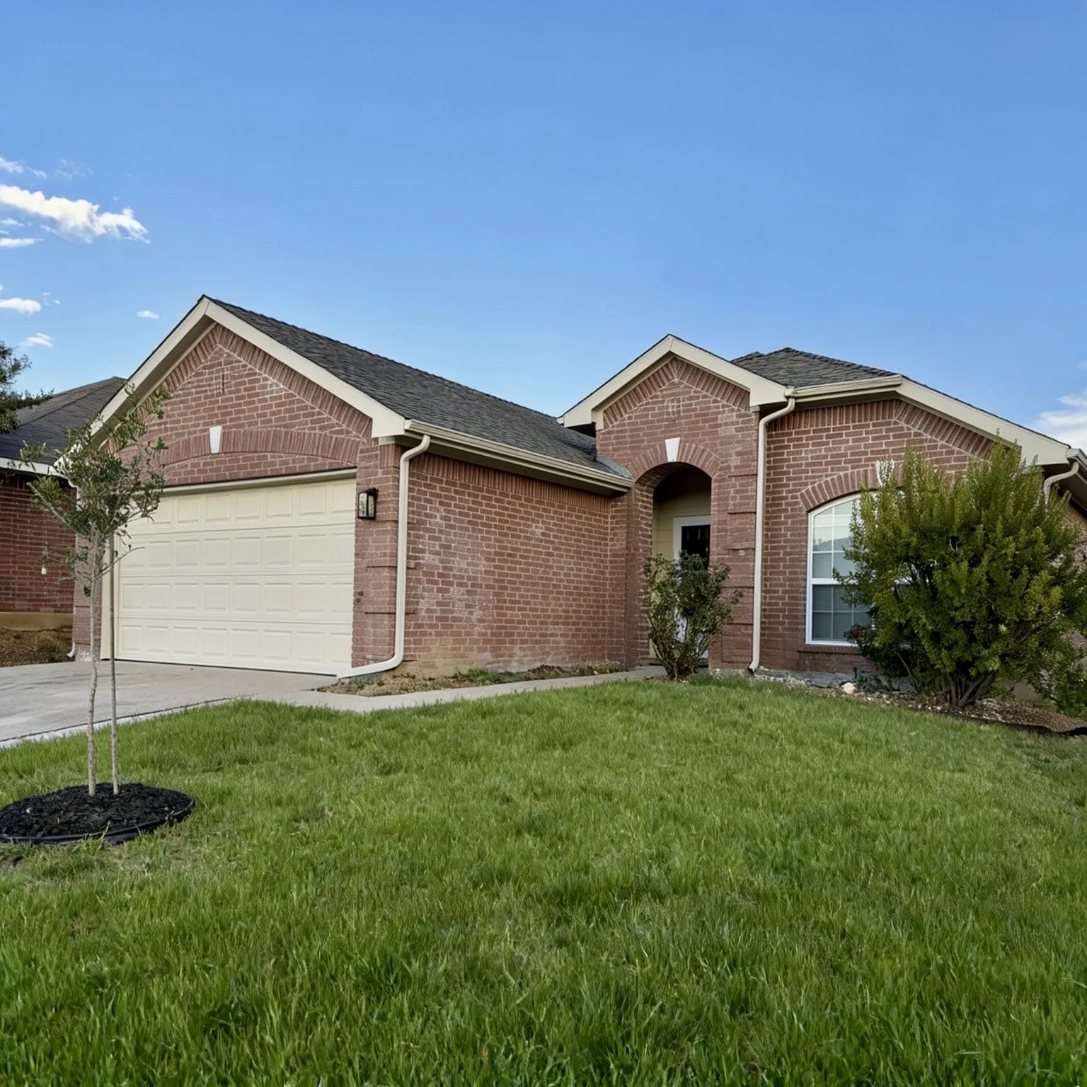 Brick exterior with a two-car garage