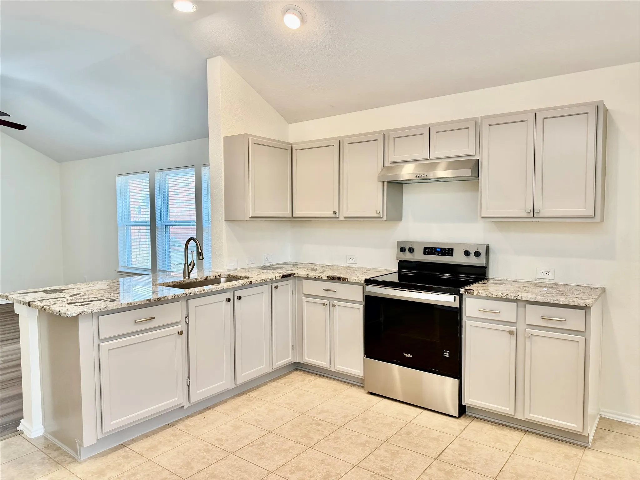 Kitchen featuring light-toned cabinetry, granite countertops, stainless steel appliances, and tile​​‌​​​​‌​​‌‌​‌‌​​​‌‌​‌​‌​‌​​​‌​​ flooring