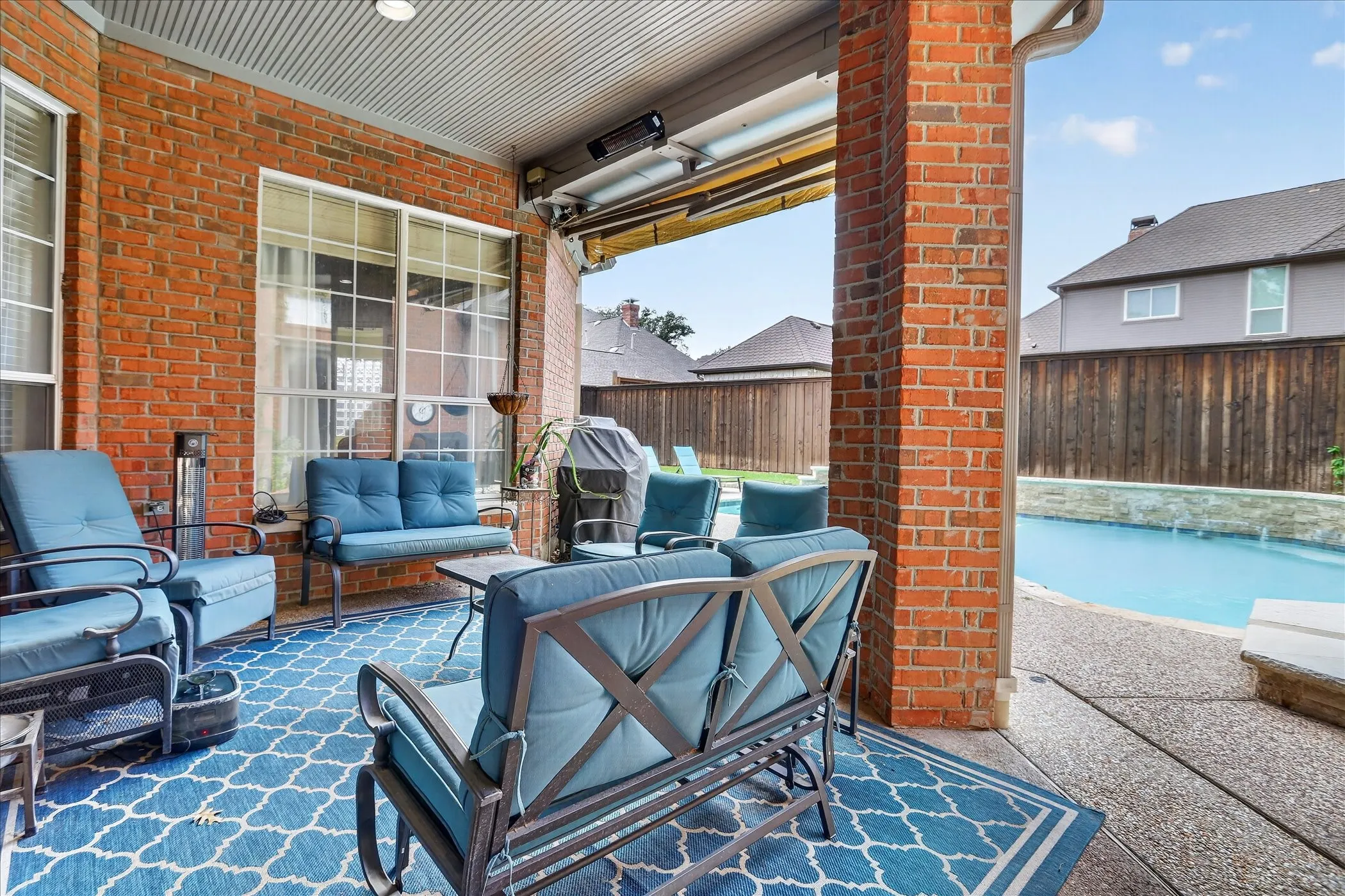 Covered patio with retractable sun shade.