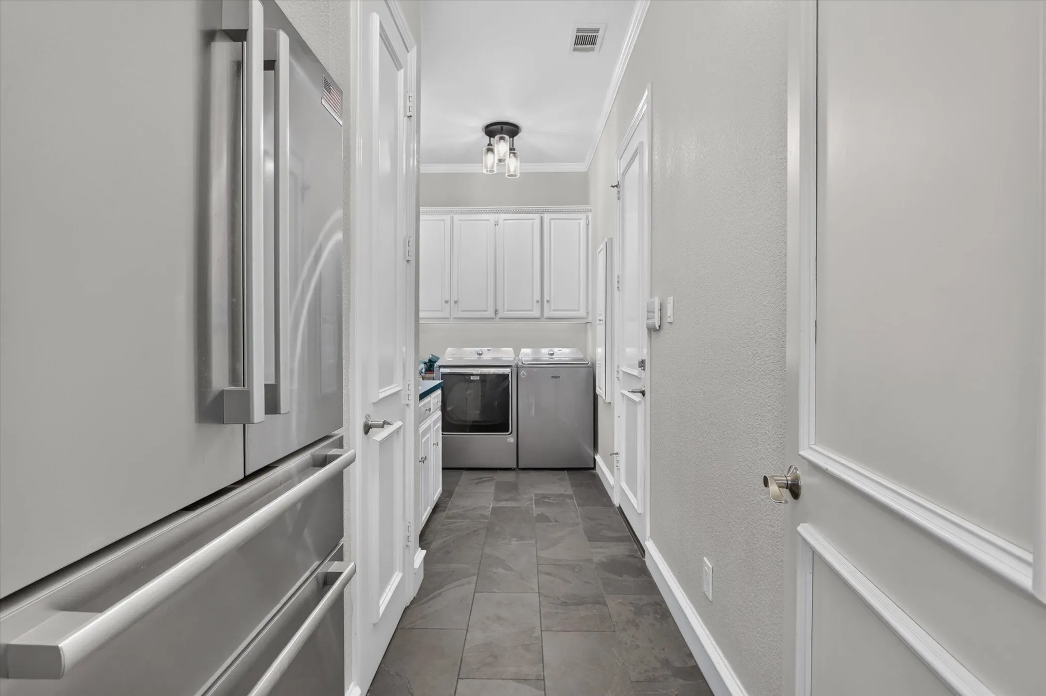 Garage enters through utility room and it includes space for a refrigerator, a full closet and upper cabinet storage. Also, has gas hook up.
