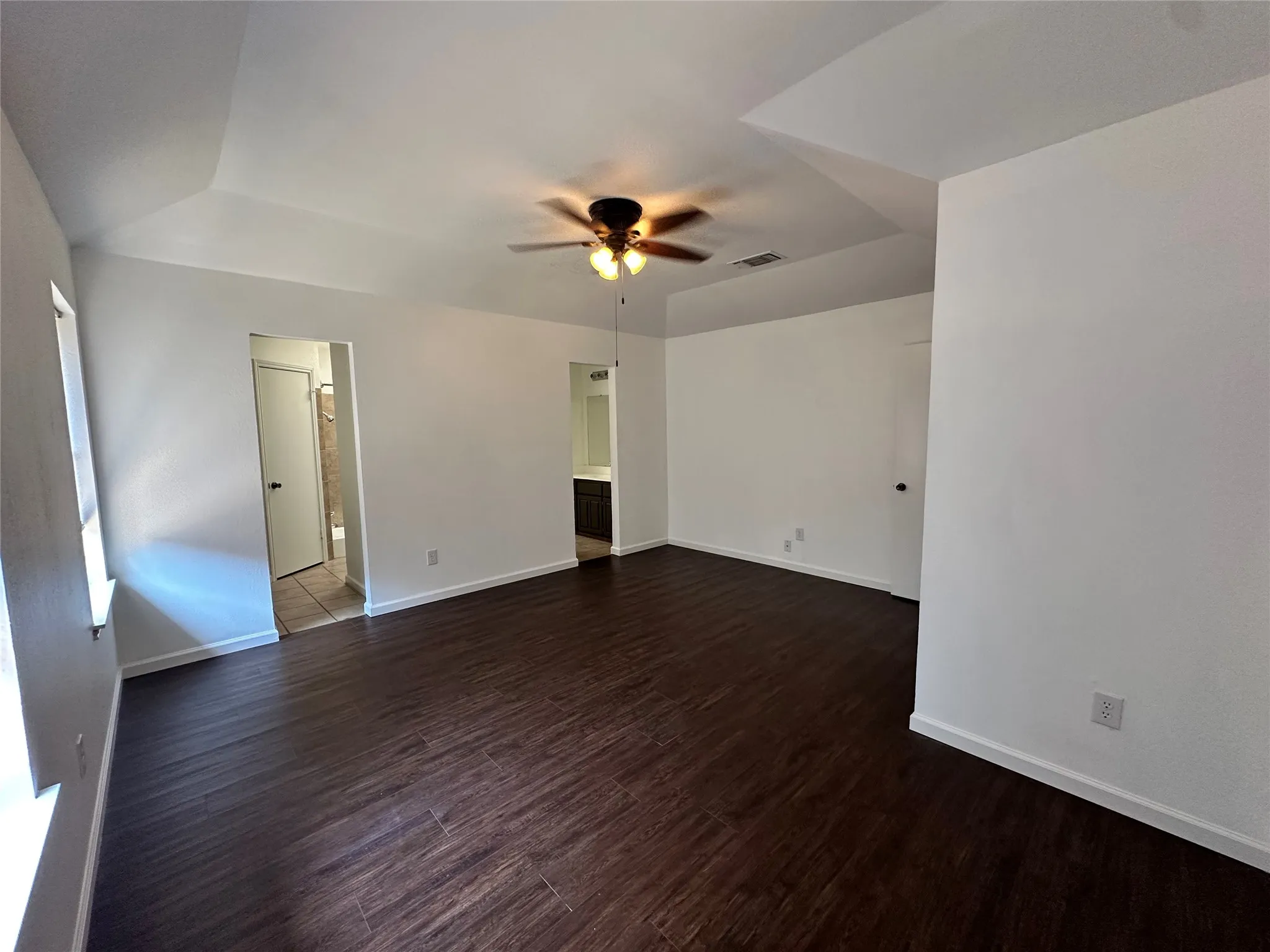 Primary suite with ensuite bath and dual walk-in closets.