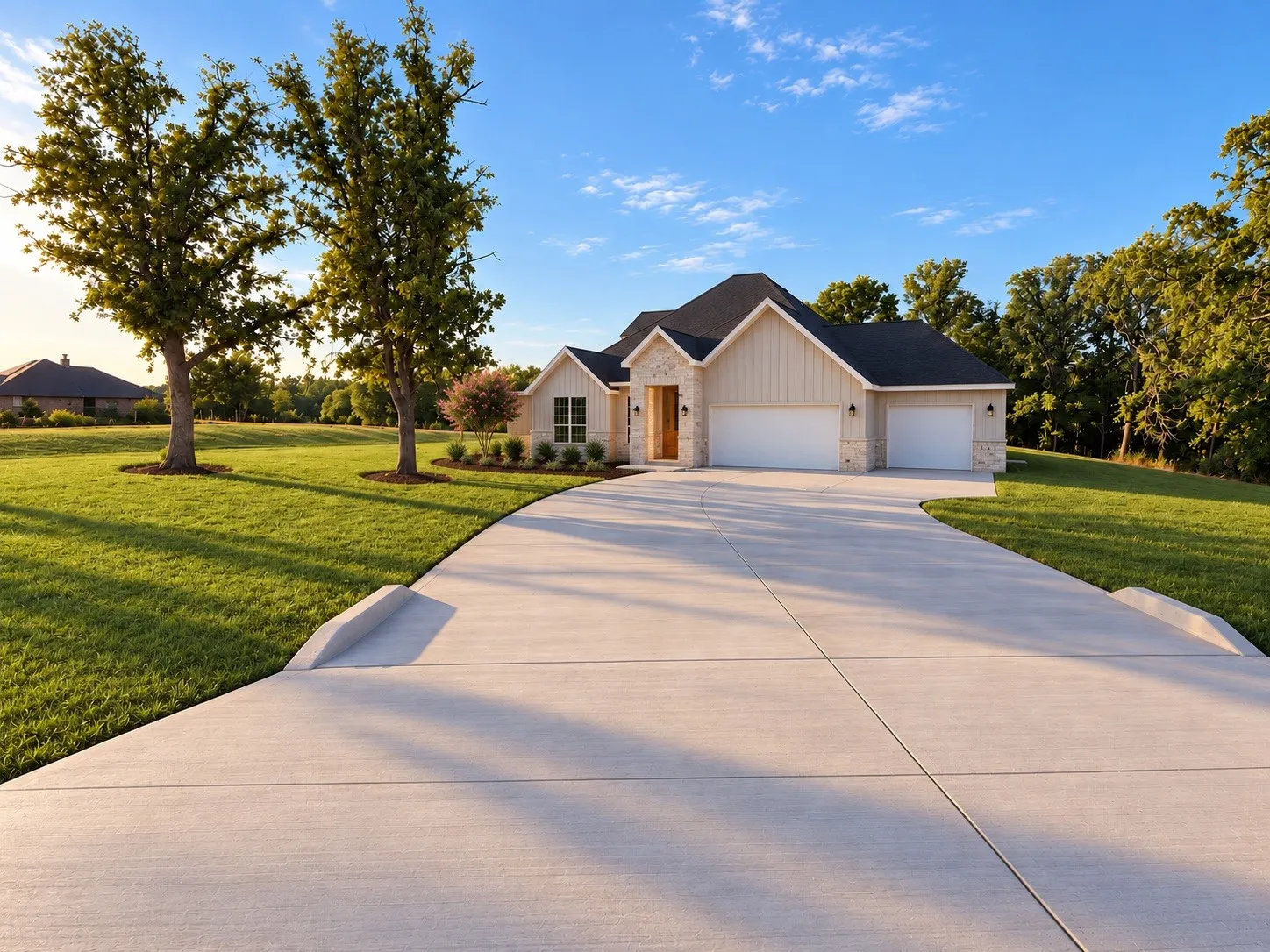 Board and batten siding, stone accents, a three-car garage, mature trees, and a concrete driveway