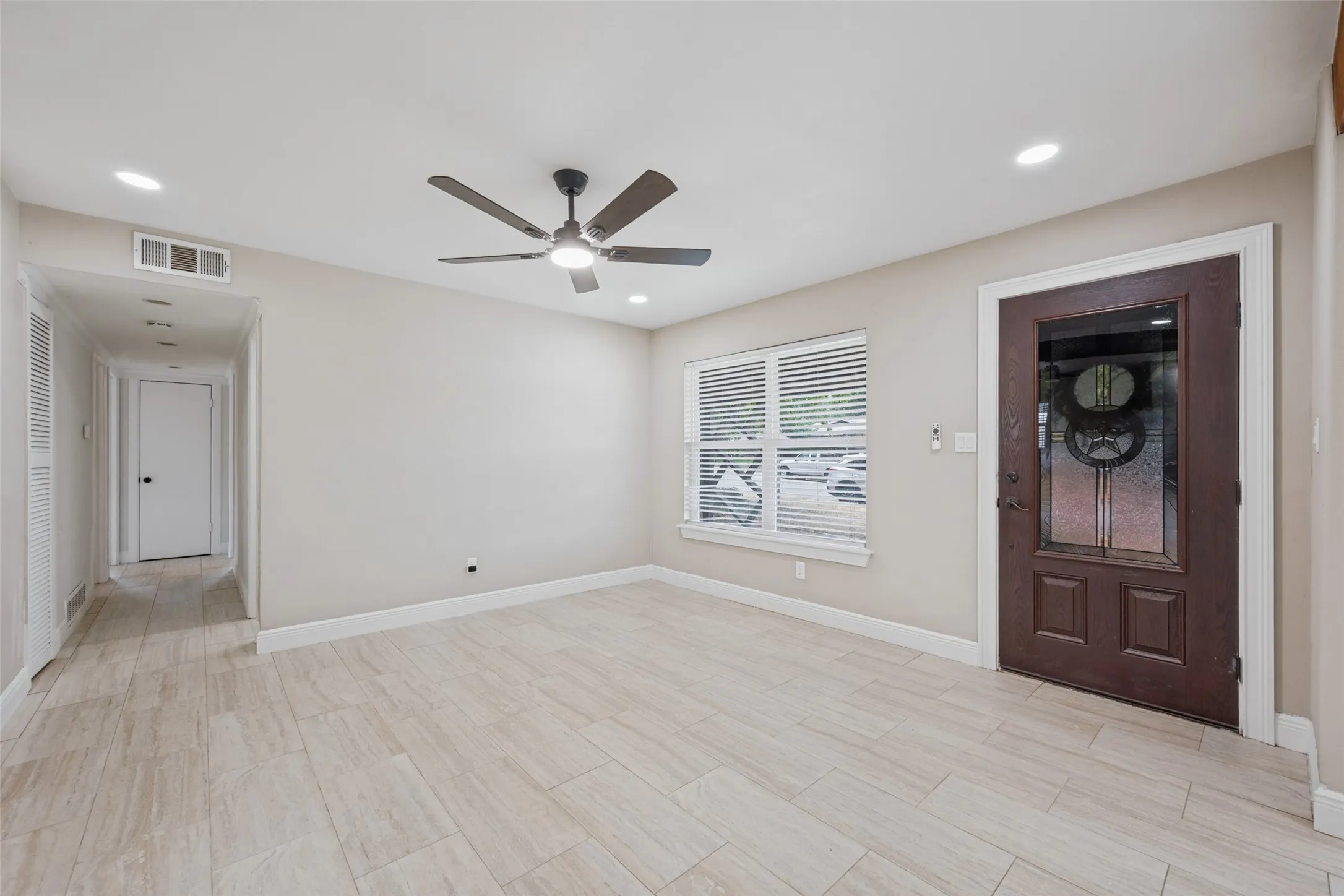 Wood-finish tile flooring throughout, recessed lighting, and a ceiling fan with integrated light
