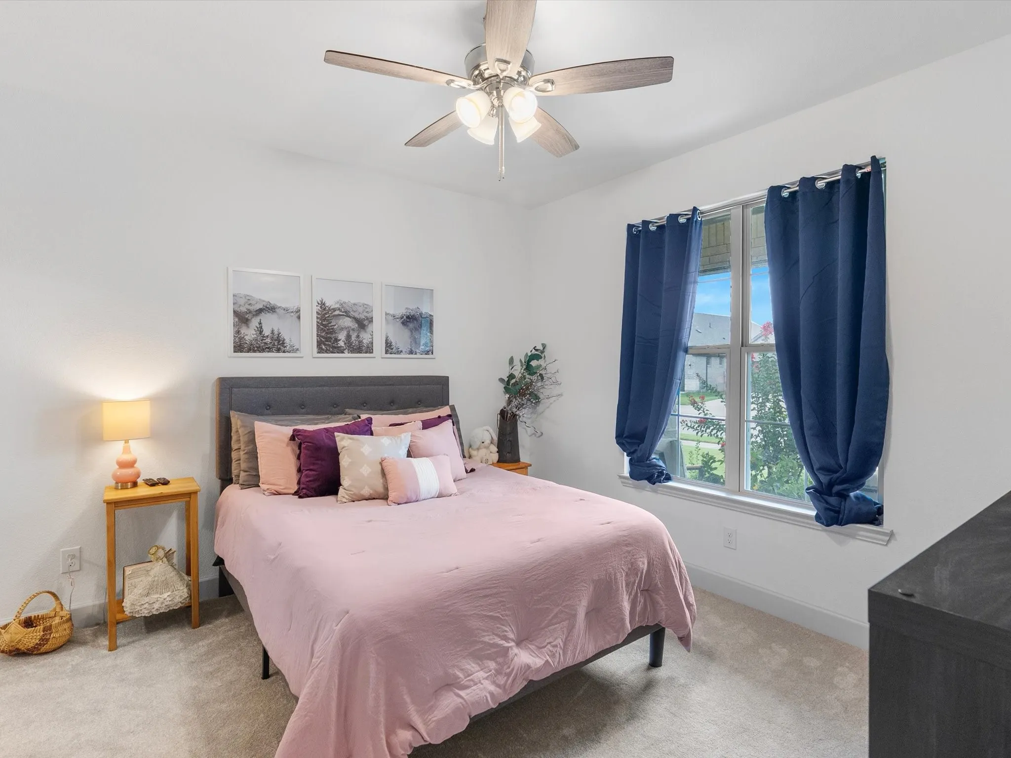 Carpeted flooring with a neutral finish, a window with a white frame, and a ceiling fan with integrated lighting