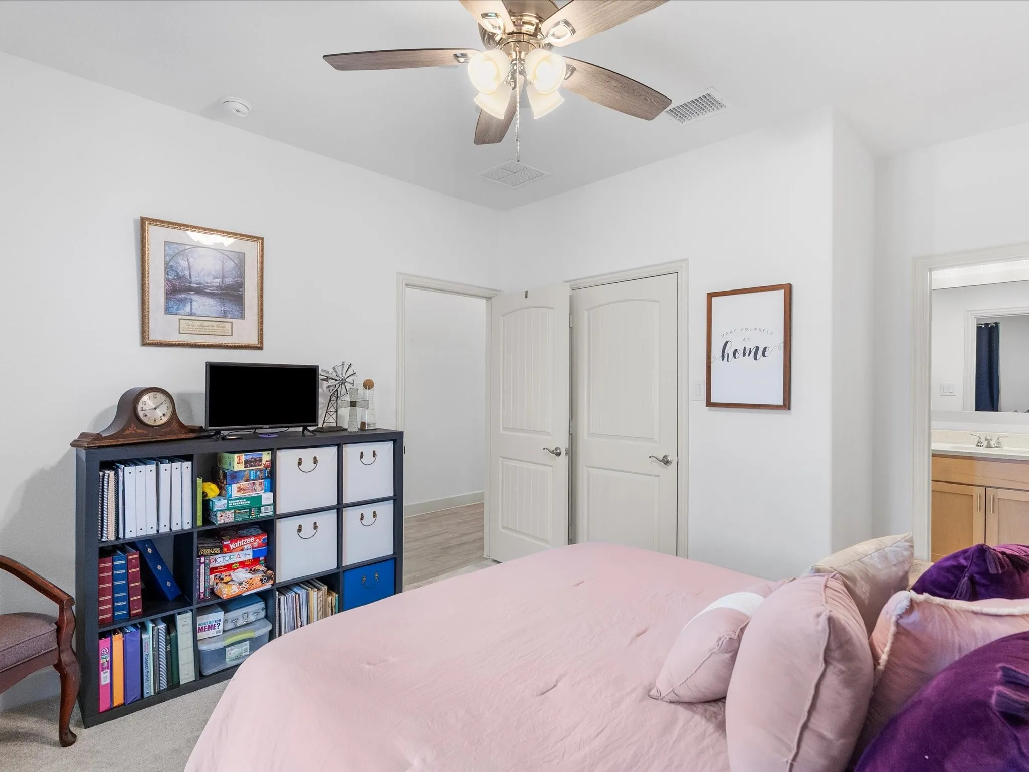 Ceiling fan with integrated lighting, white interior doors, and light-toned walls