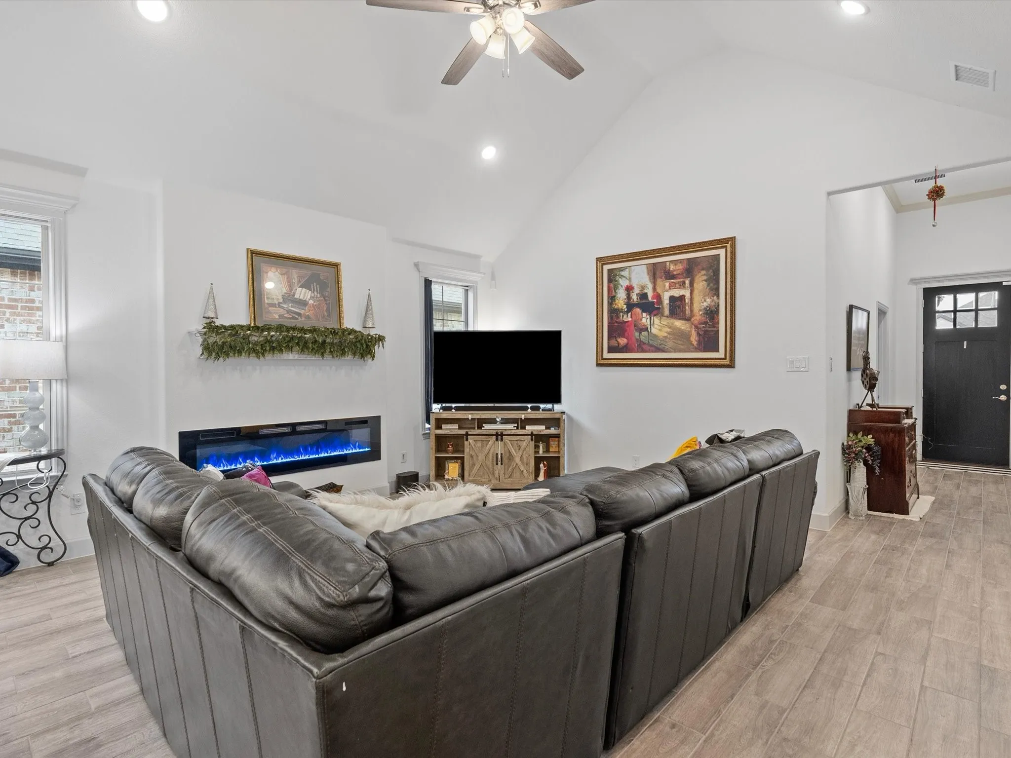 Vaulted ceilings, recessed lighting, and a contemporary linear fireplace
