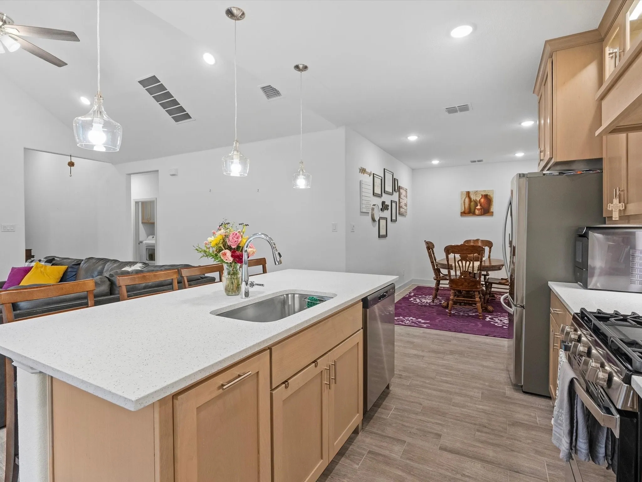 Kitchen island with an undermount sink and light-toned countertops