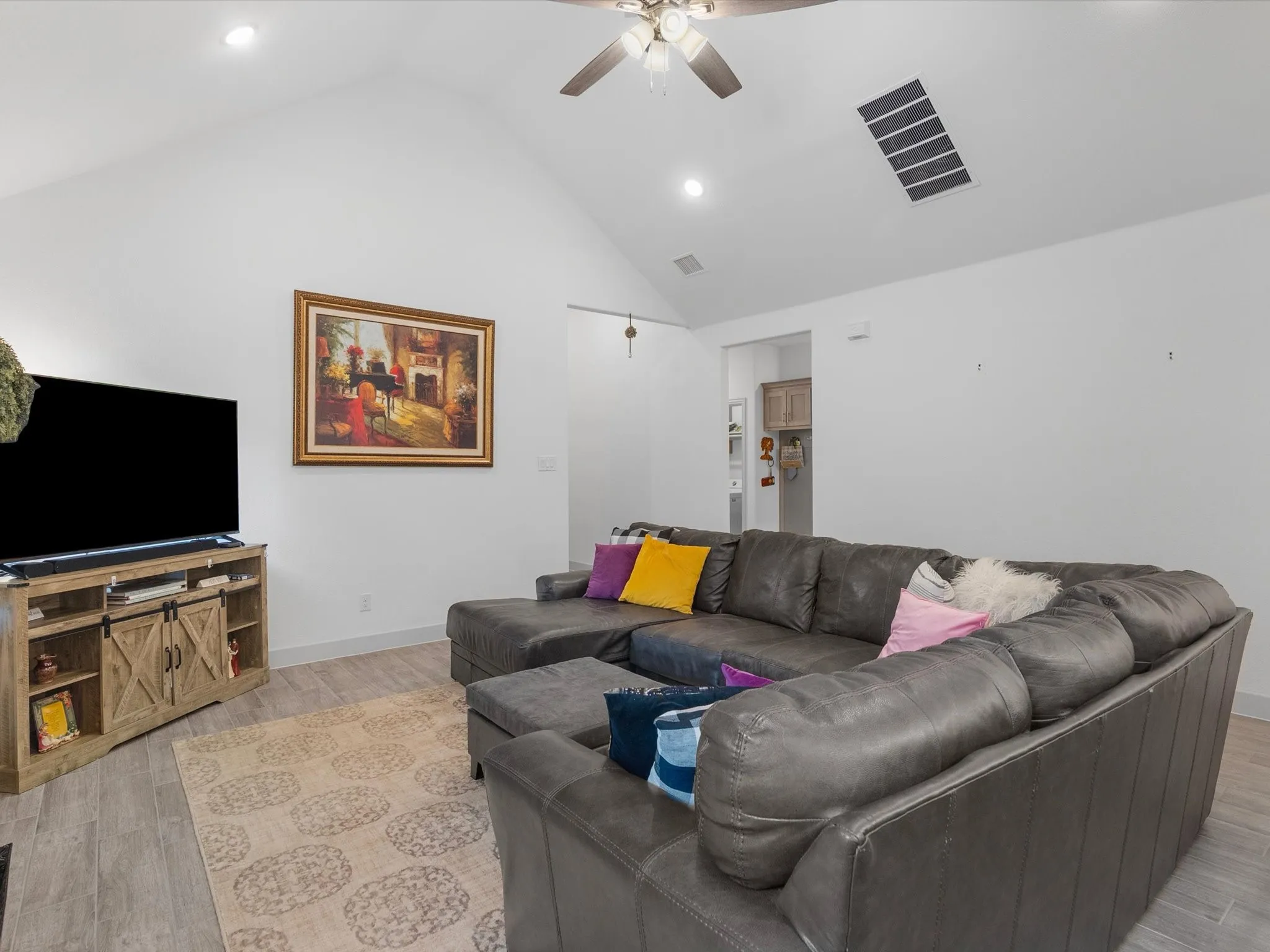 Vaulted ceiling with recessed lighting and ceiling fan