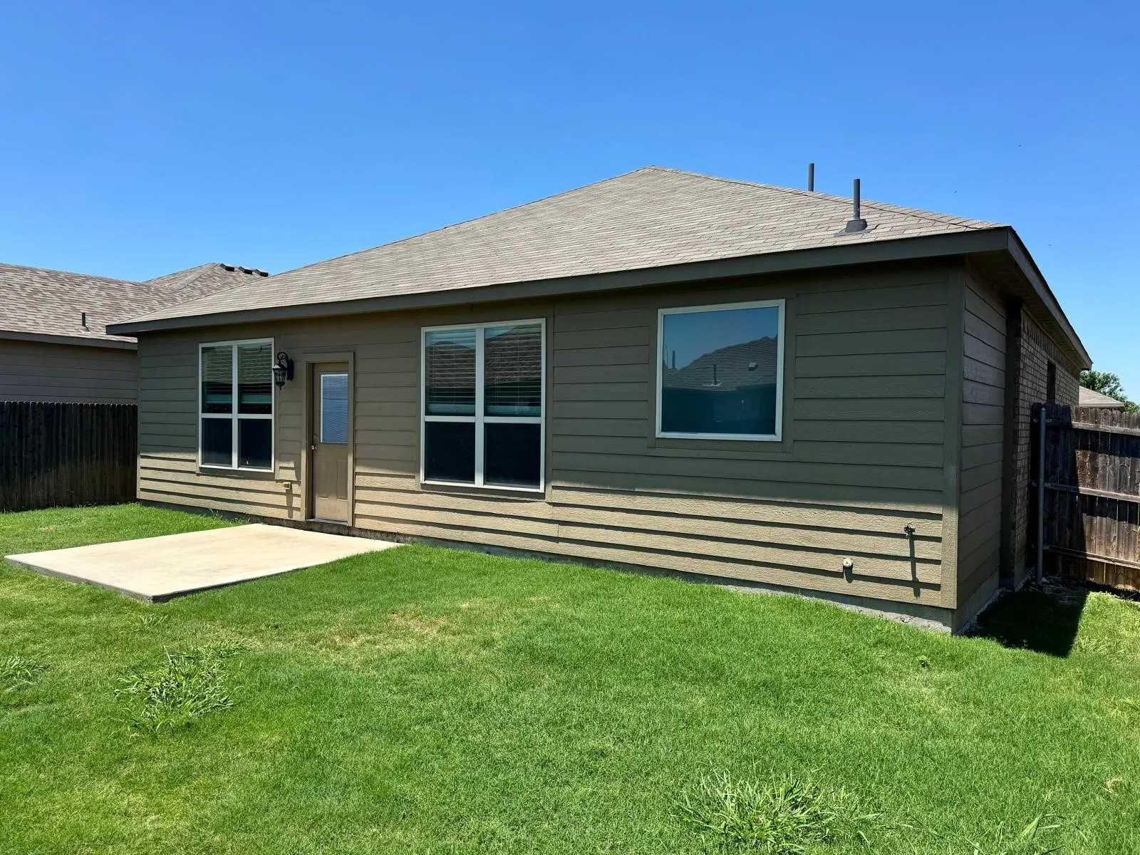 Back of house featuring a patio and a lawn