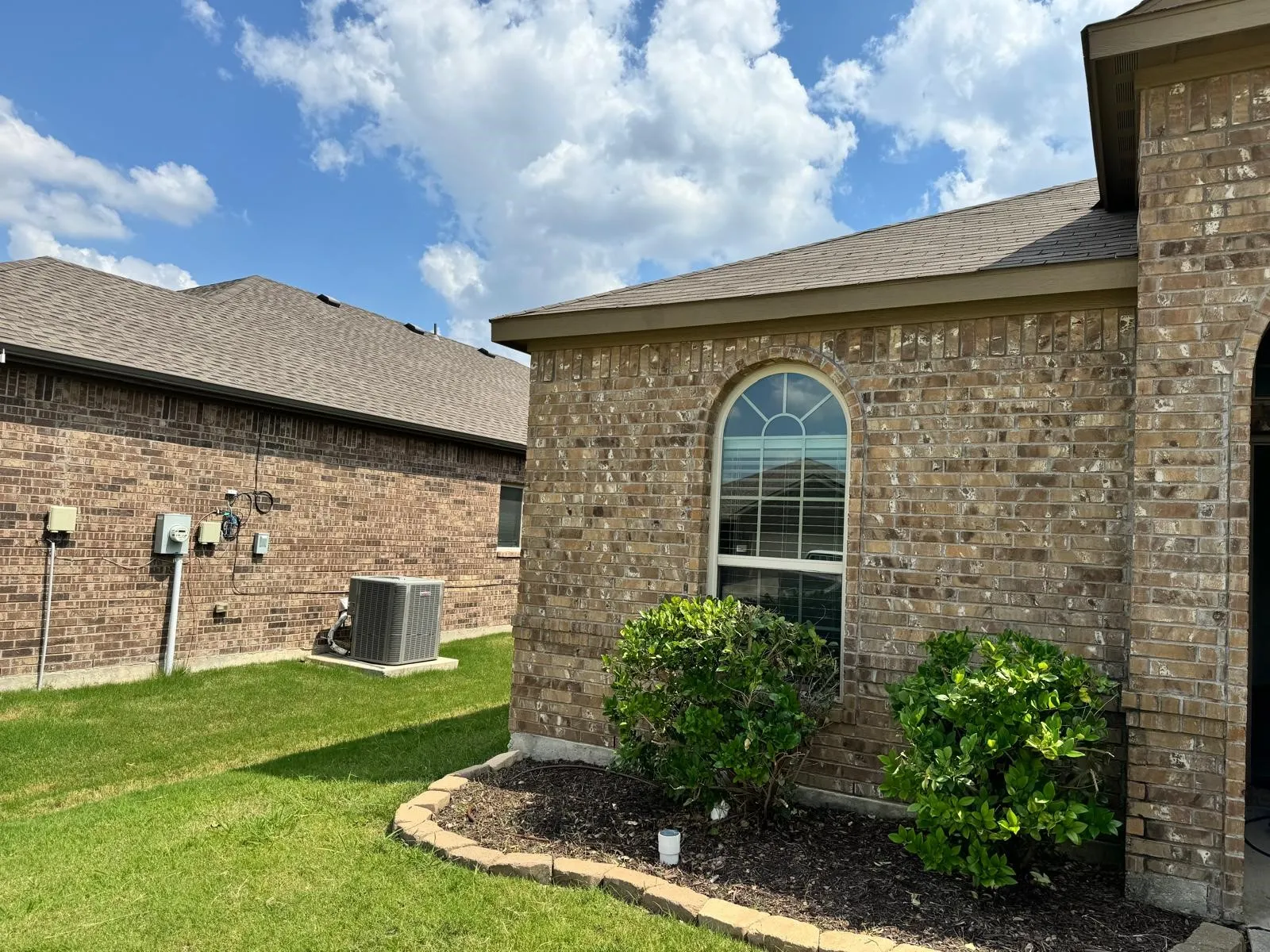 View of home's exterior featuring central air condition unit and a lawn