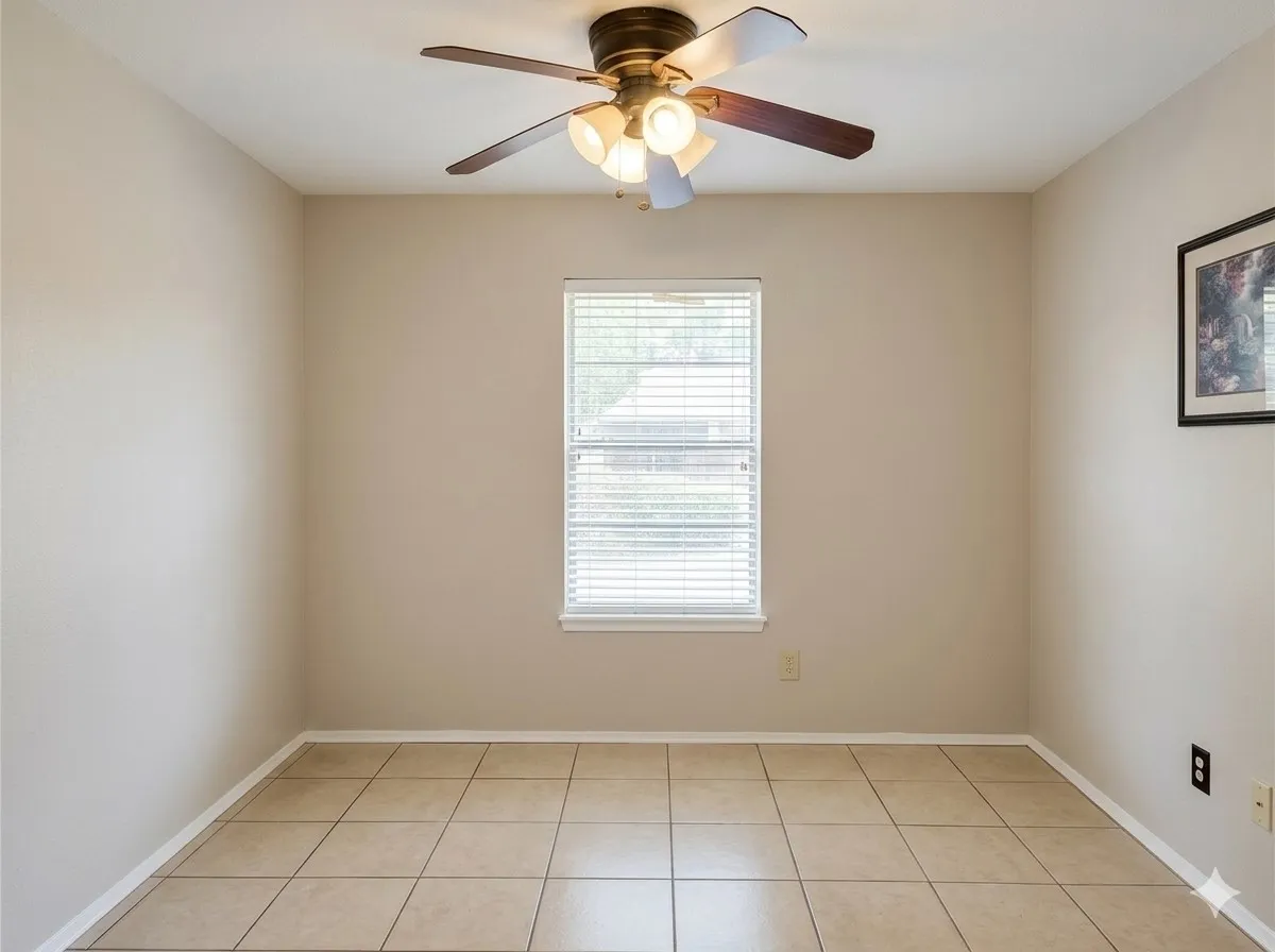 Neutral-toned walls, tile flooring, window with blinds, and a ceiling fan with integrated lighting