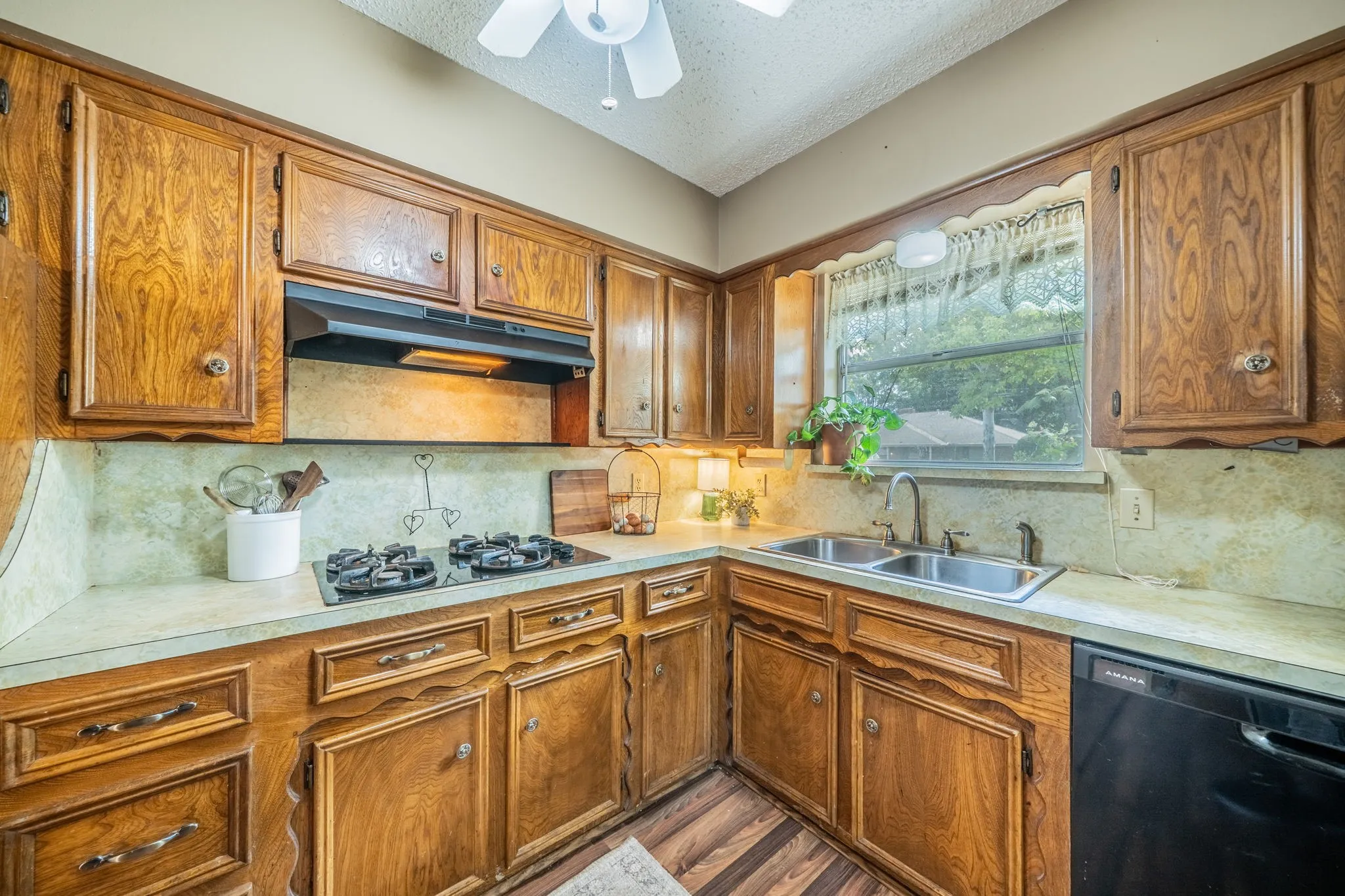 Wood-finish cabinetry and trim throughout the kitchen