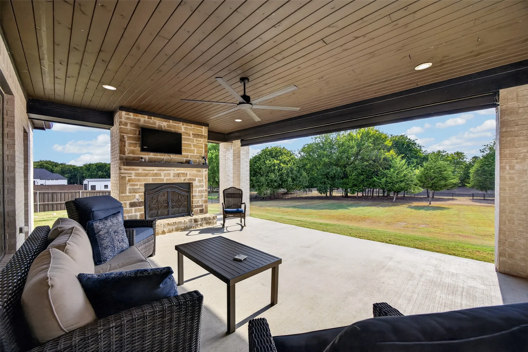 Spacious patio with wood burning fireplace and electric shade