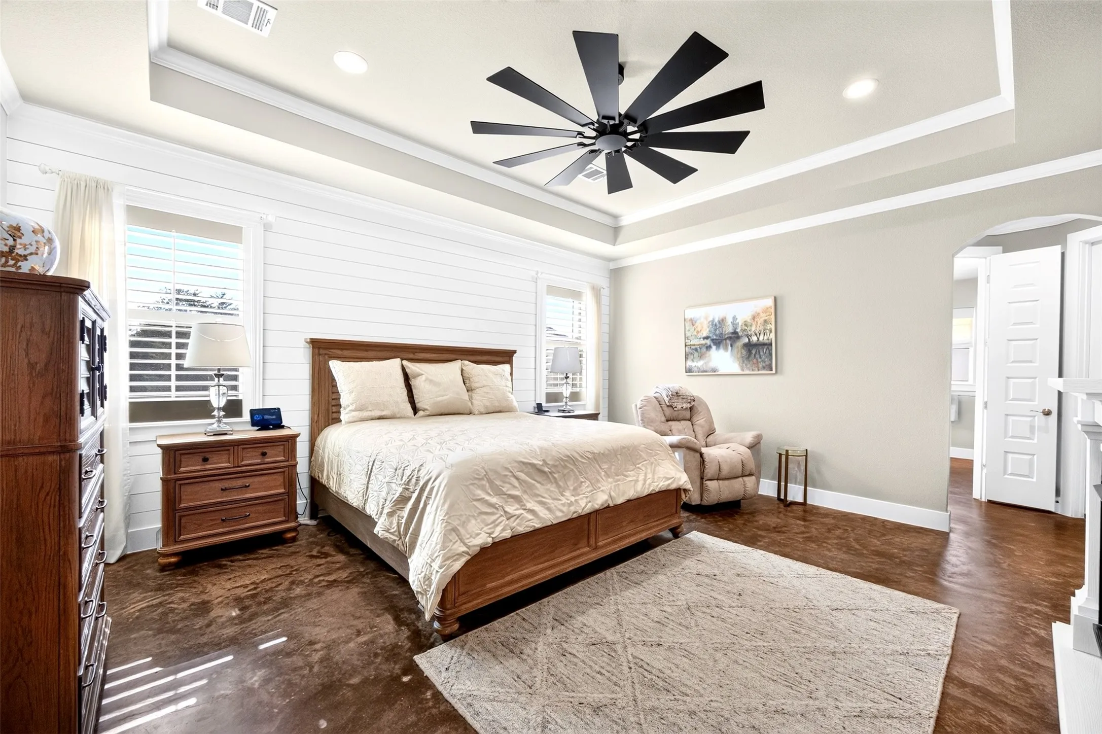 Primary suite with tray ceiling, ceiling fan, plantation shutters
