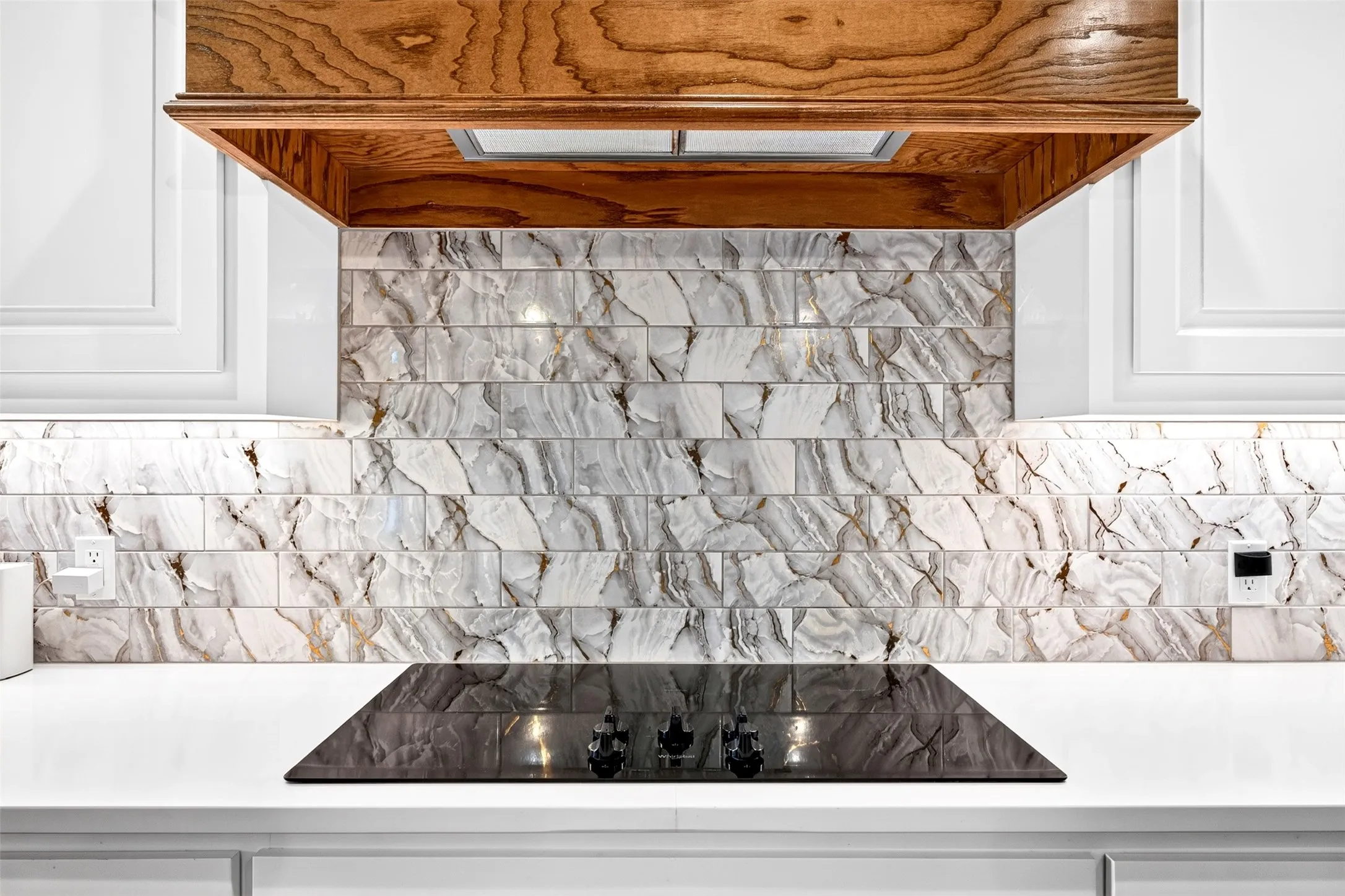 Stunning backsplash and wood ventahood