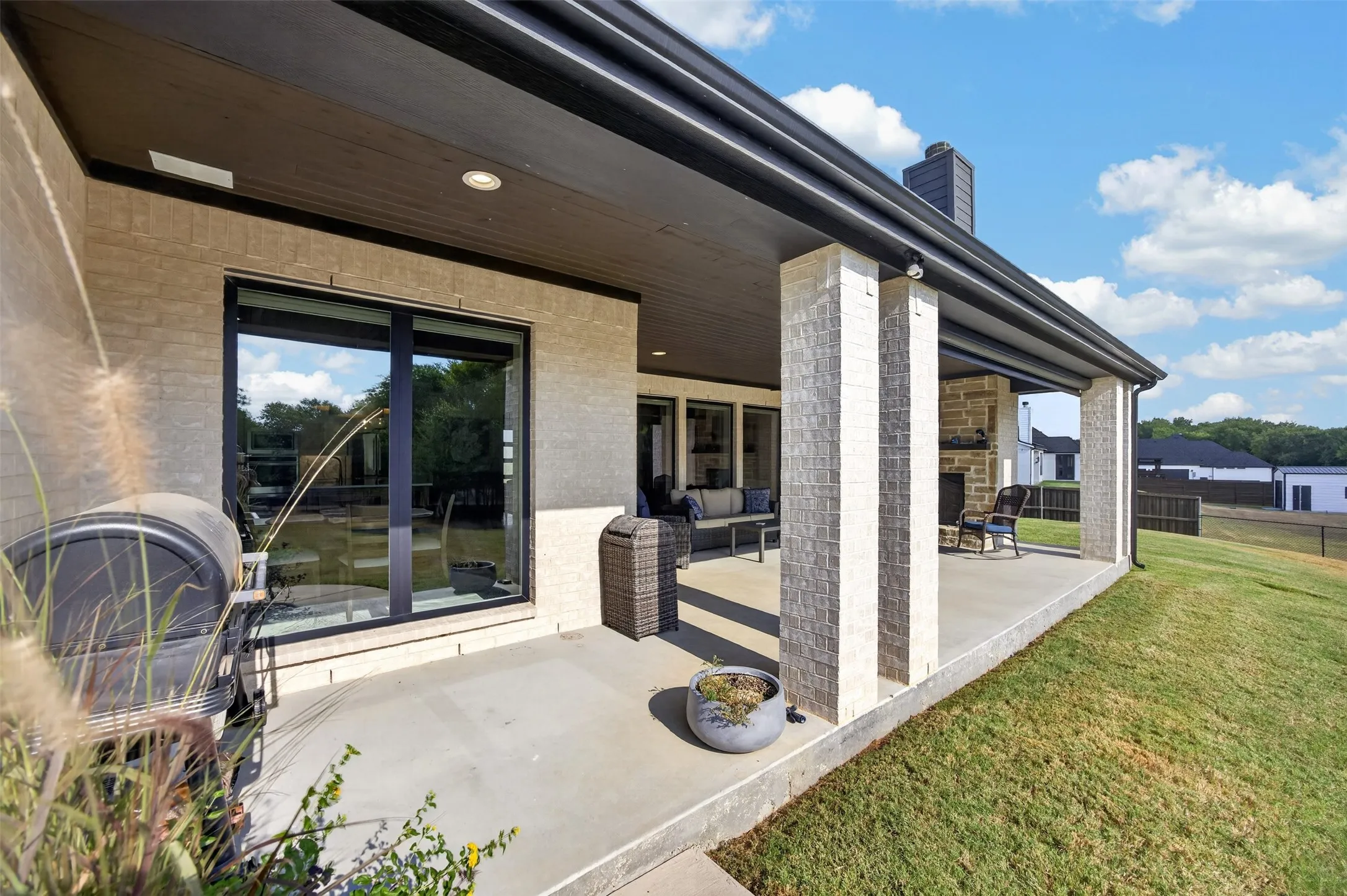 Spacious patio with wood burning fireplace and electric shade