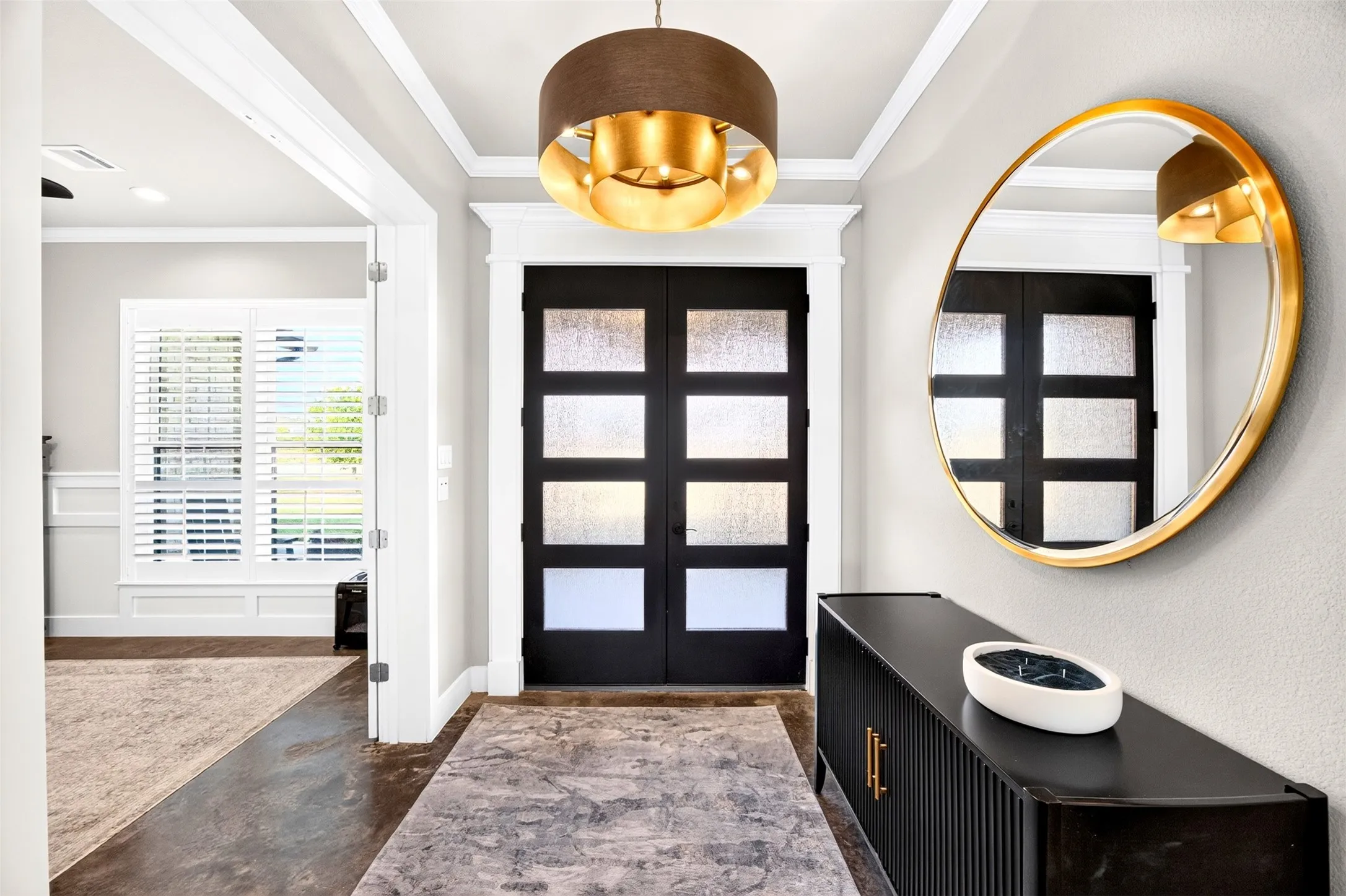 Stunning entry with double front doors and designer lighting and French doors to office