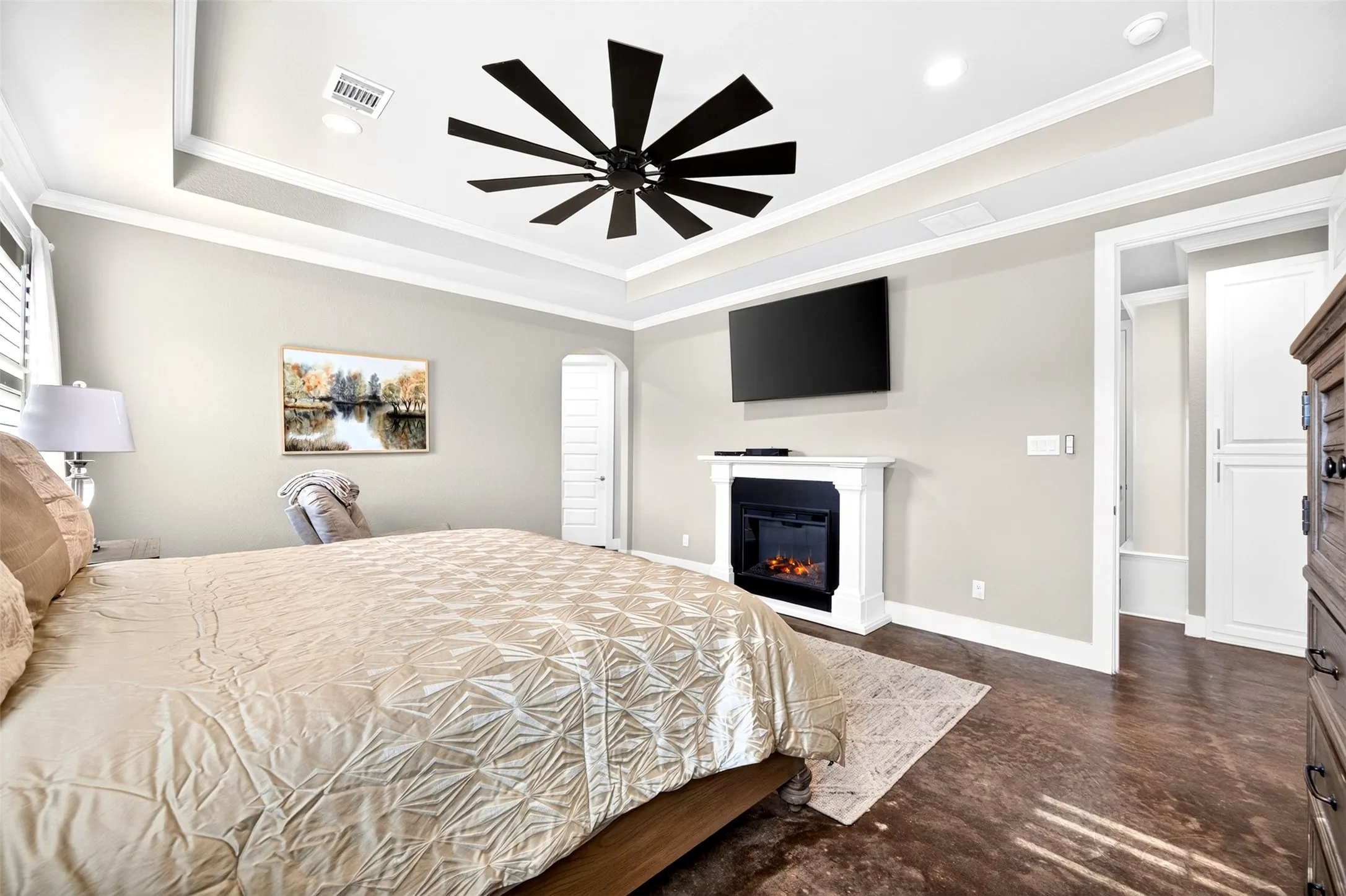 Primary suite with tray ceiling, ceiling fan, plantation shutters