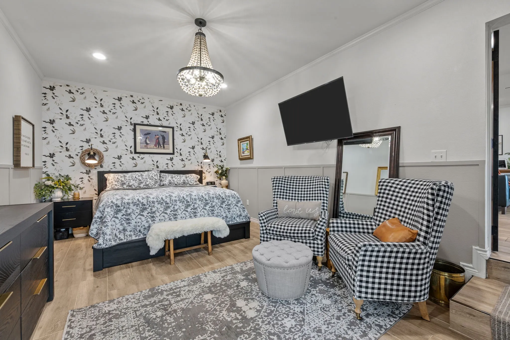 Recessed lighting, chandelier, wainscoting, wood-finish flooring, and accent wall