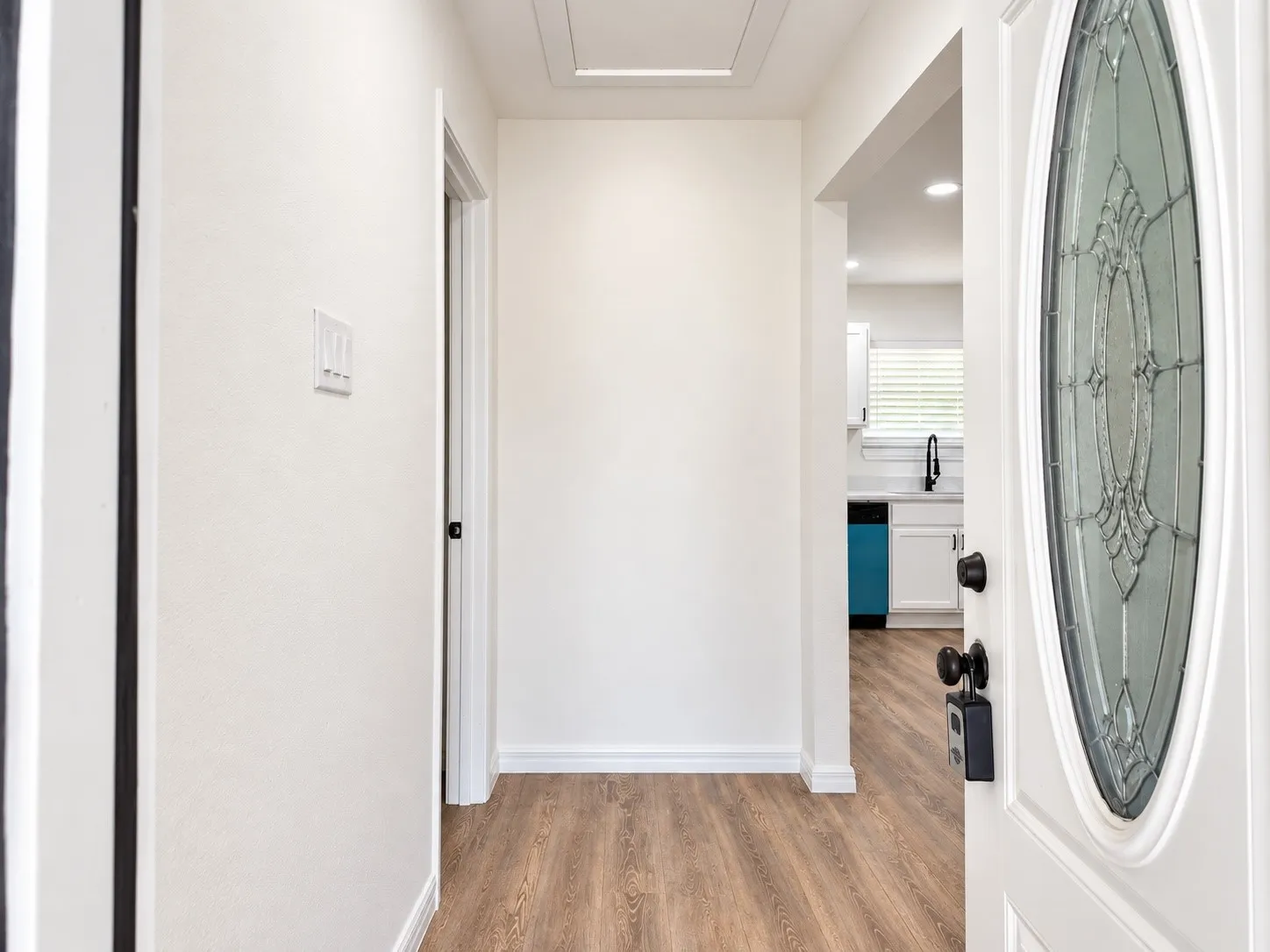 Bright entry foyer with a direct sightline toward the updated kitchen.