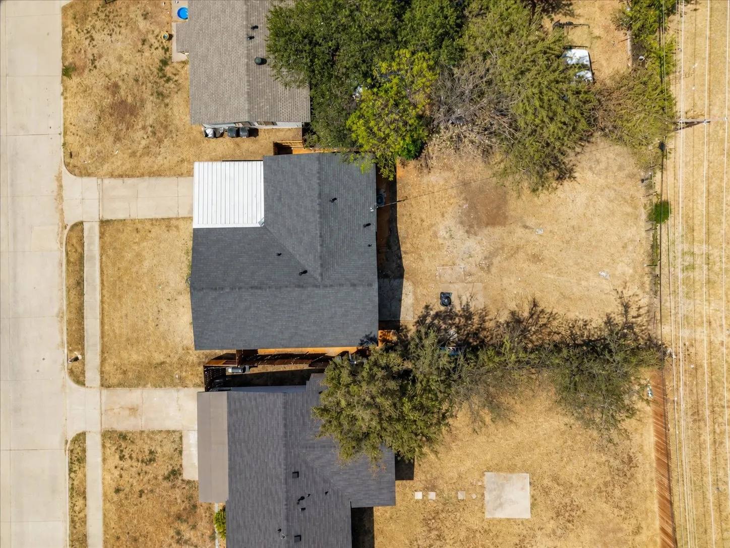 Wide rear view showing the home's front and backyard setting.