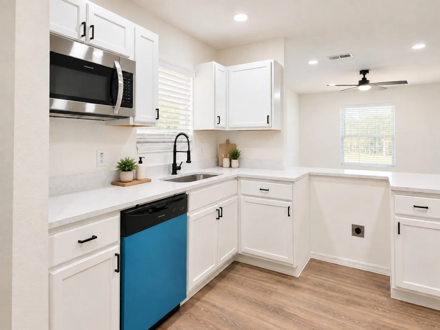 Kitchen view of surrounding cabinetry. Decor is virtually staged.