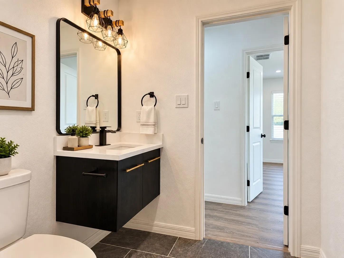 Updated full bath featuring a modern floating vanity, contemporary fixtures and tile flooring. Decor virtually staged.