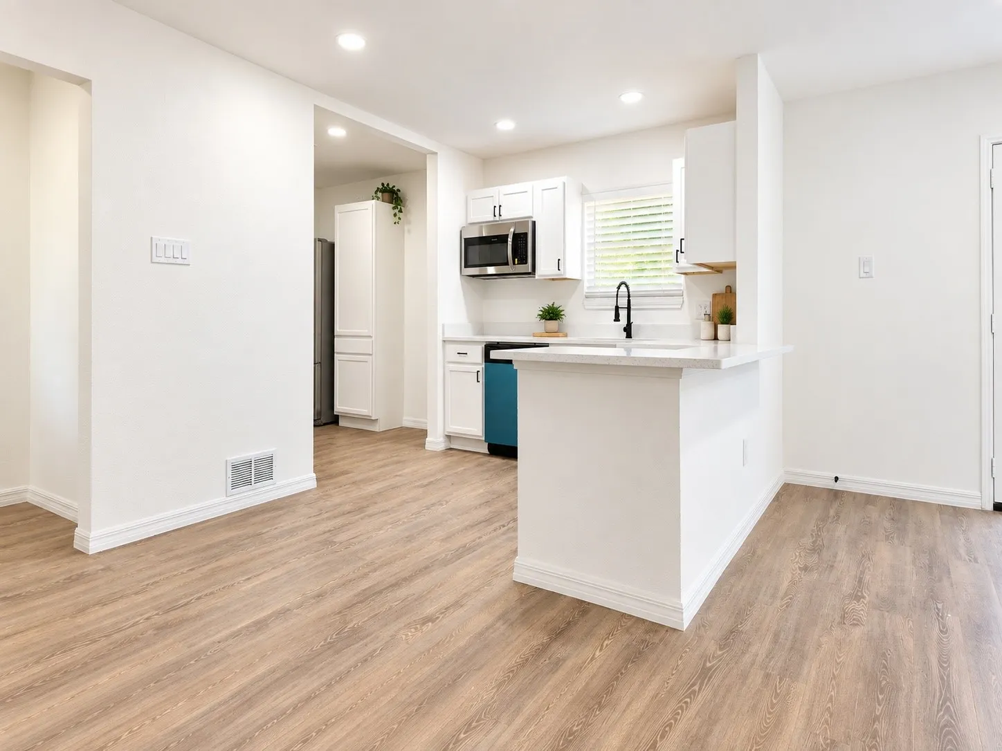 Eat-in kitchen. Decor is virtually staged.