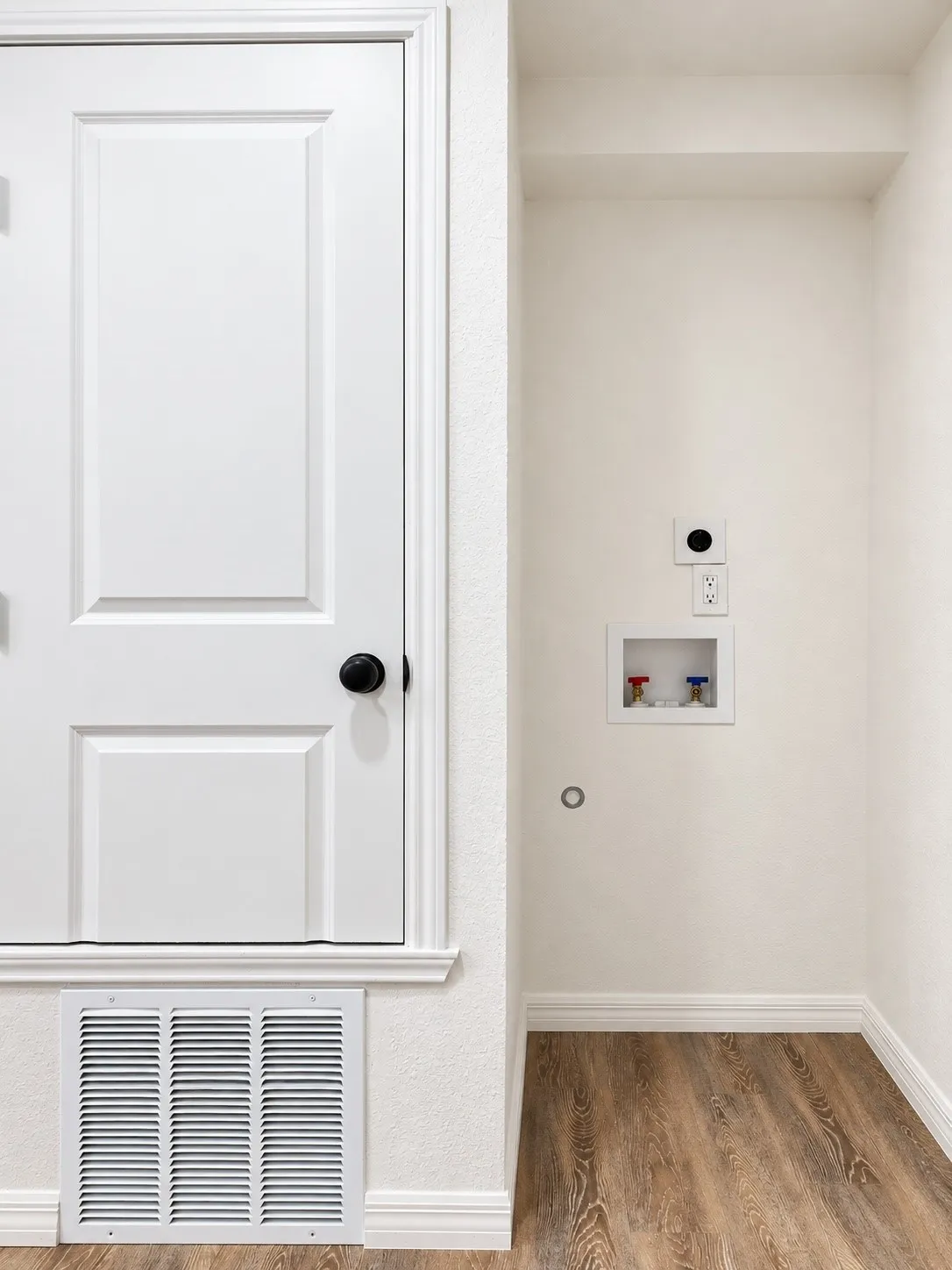 Laundry area for stacked washer and dryer connections.