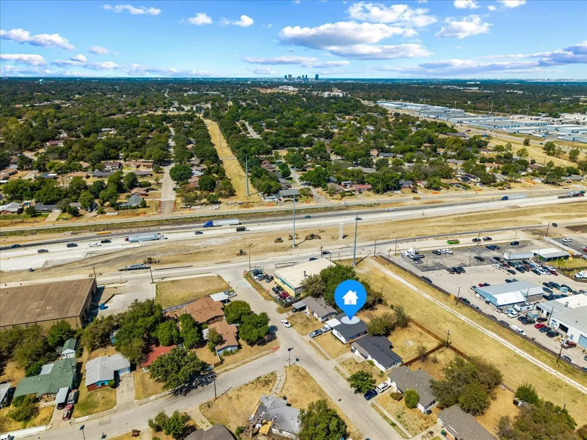 Wide aerial showing the property's location relative to the surrounding neighborhood and Hwy 820.