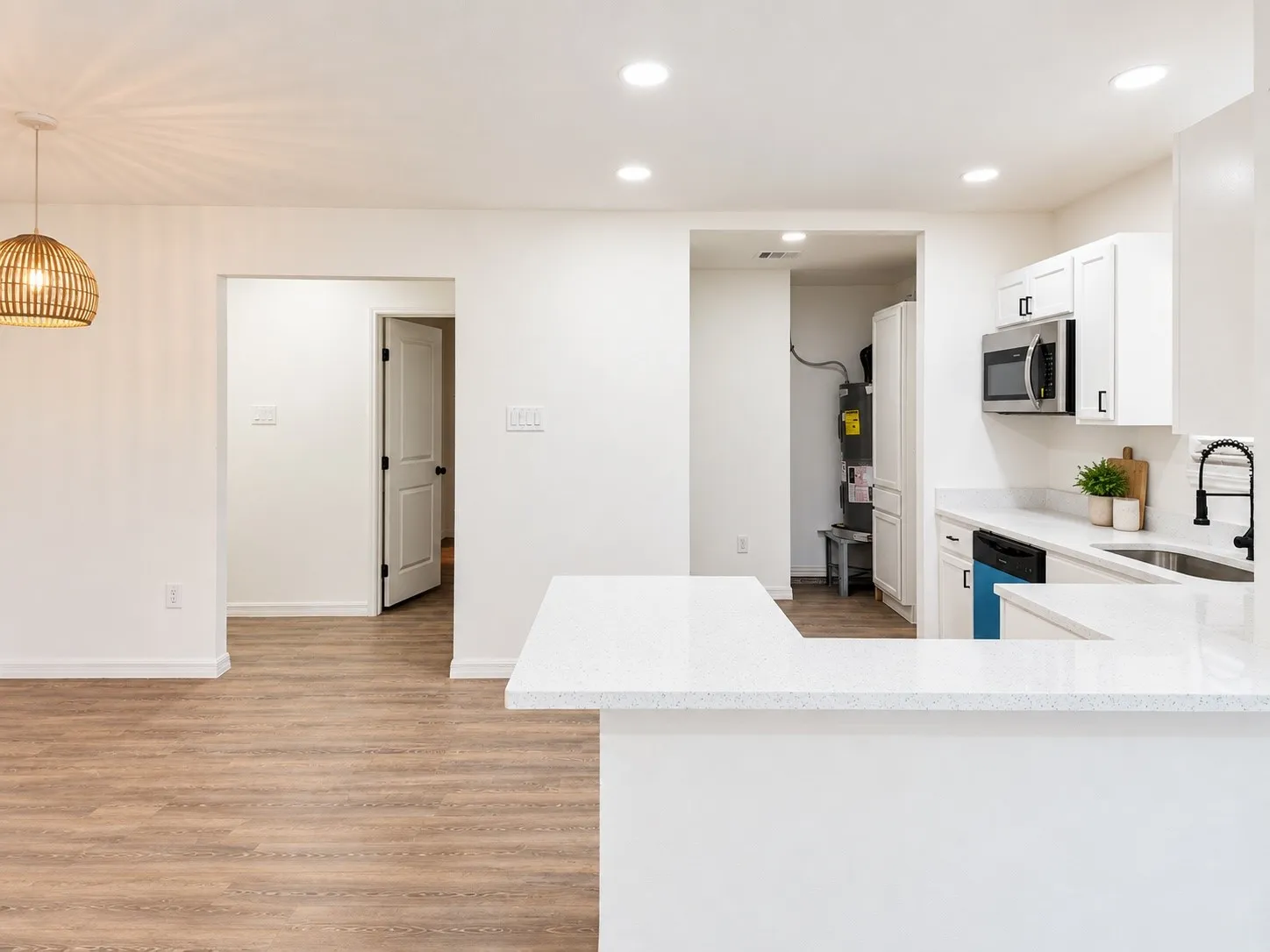 Additional kitchen angle showing access to the adjacent utility area.