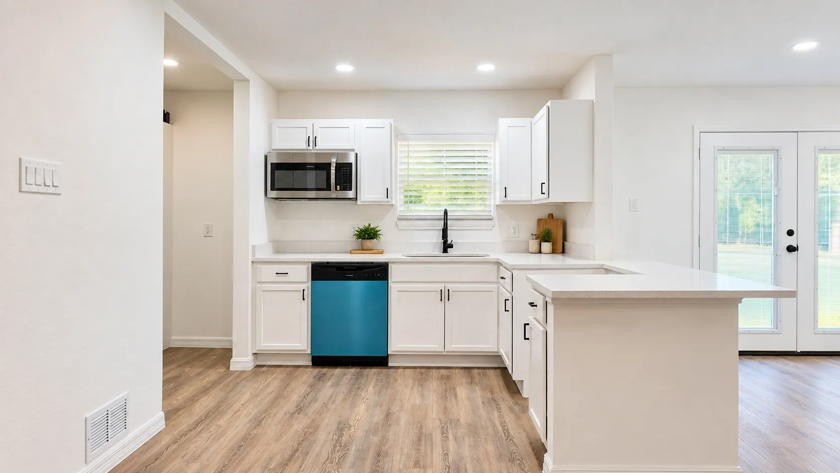 Bright, updated finishes with white cabinetry, generous counter space and a functional breakfast peninsula. Decor is virtually staged.