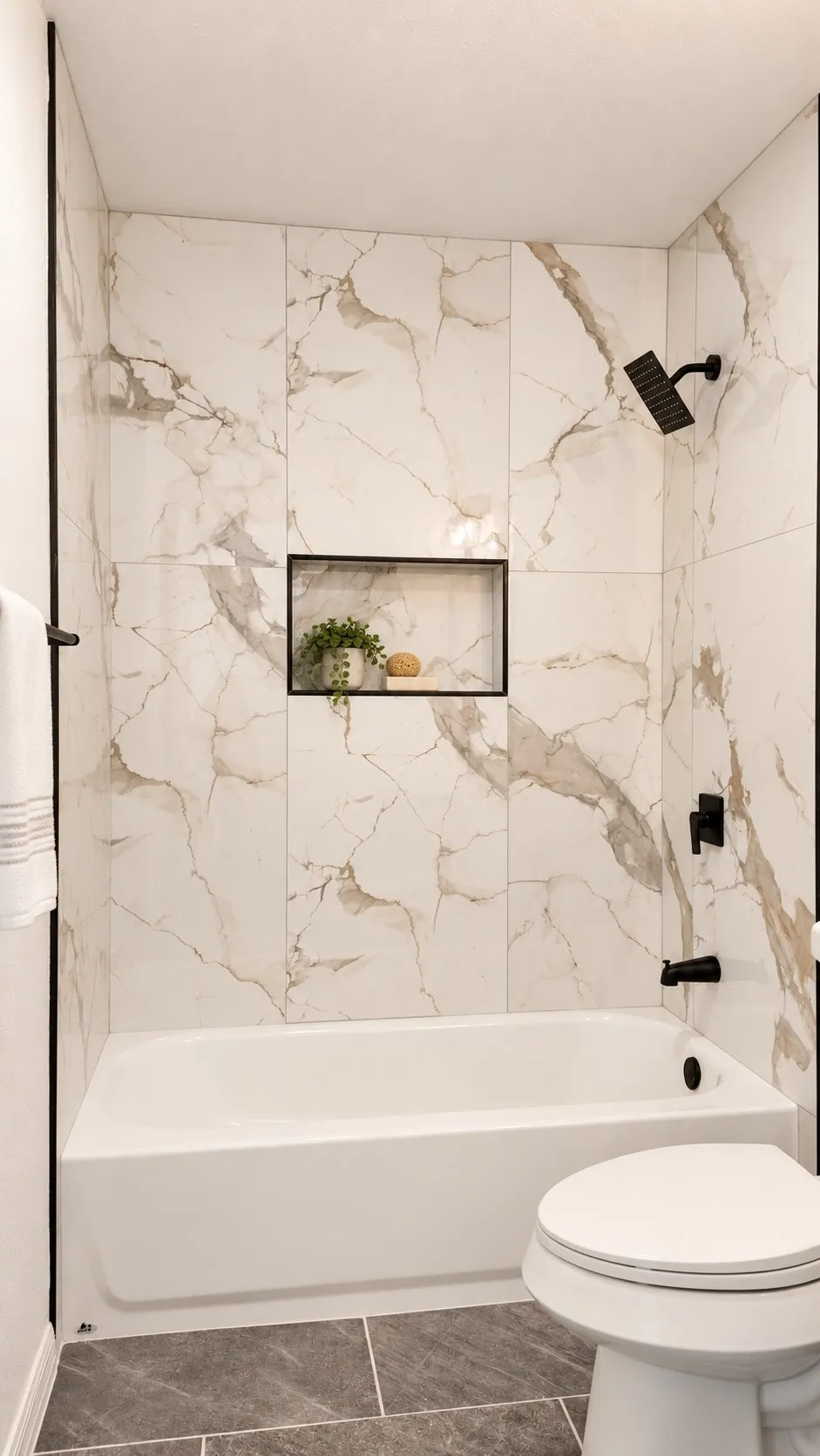 Full bath with tub-shower combination, marble-look surround, and matte black fixtures. Decor virtually staged.
