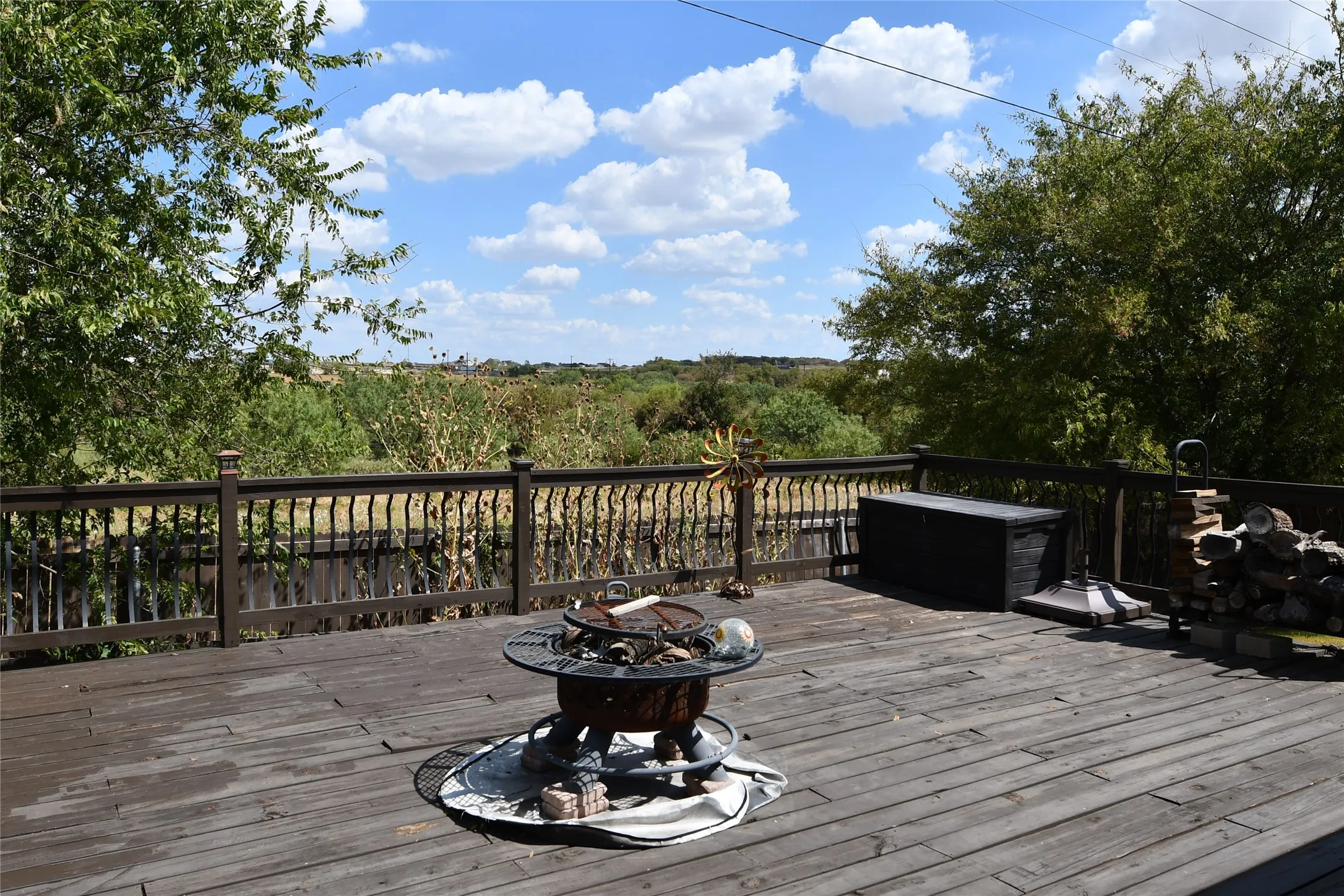 Expansive outdoor deck with wood-finish flooring and a decorative railing