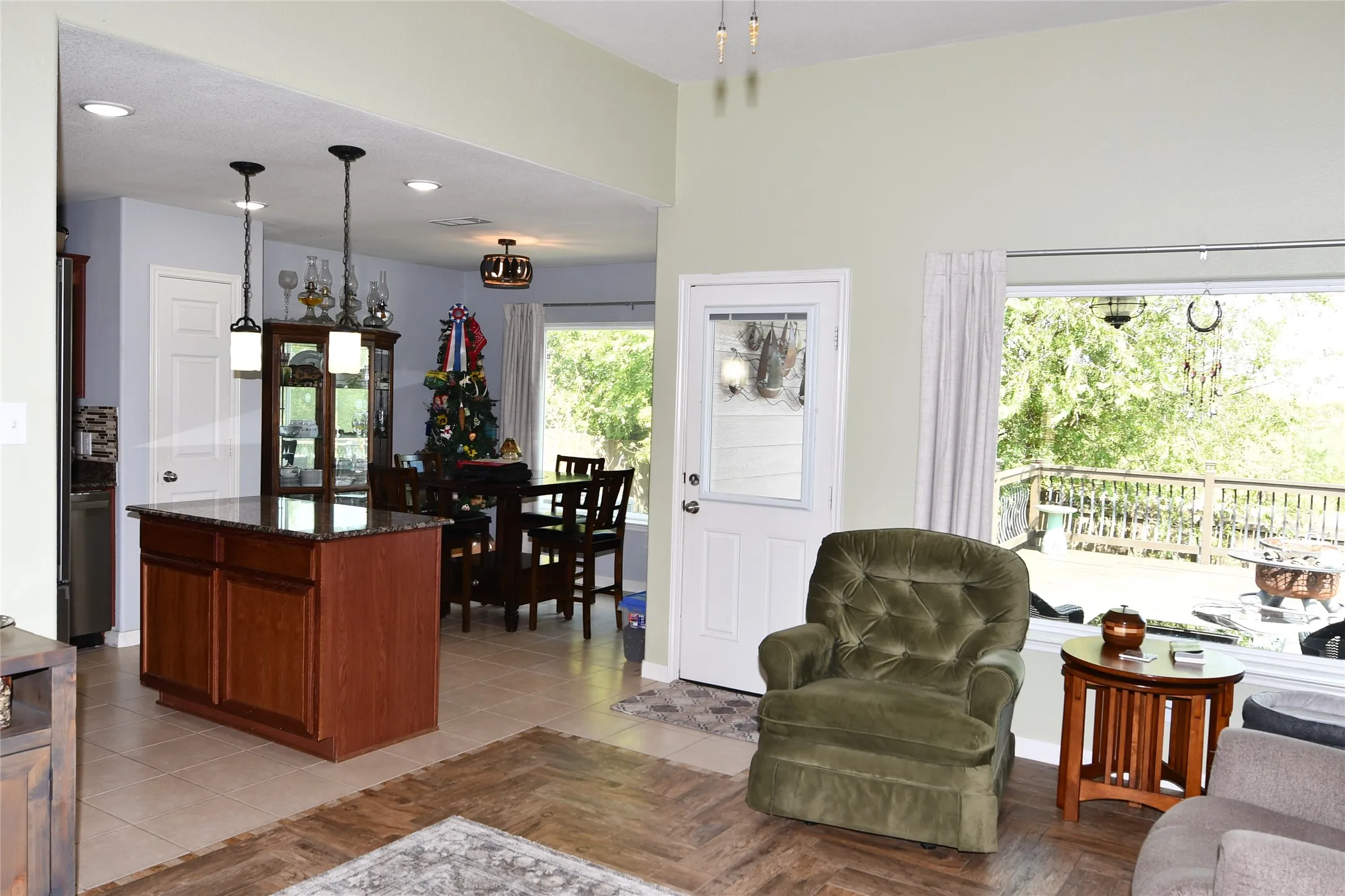 Kitchen island with granite countertop and pendant lighting
