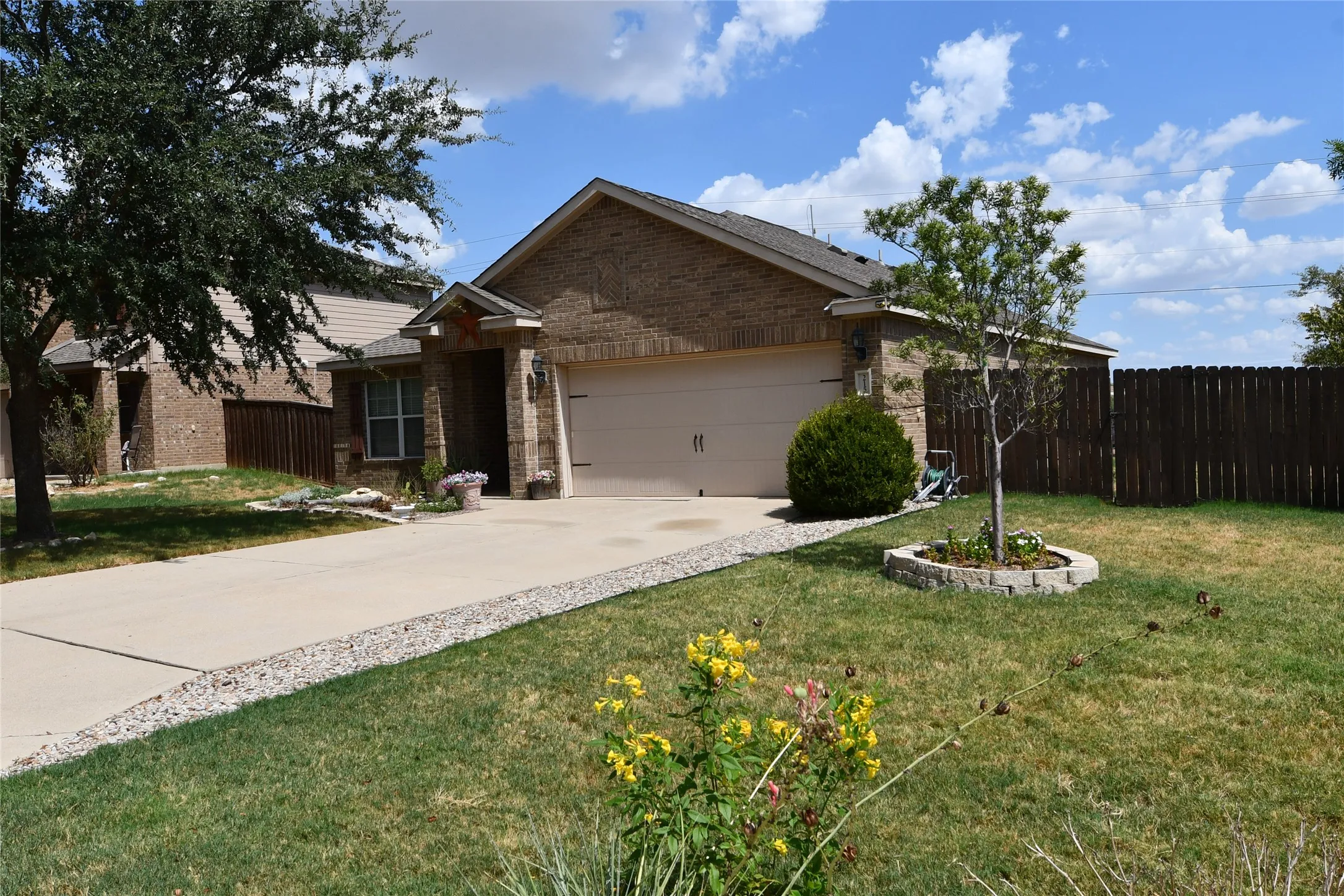 Brick exterior with a gabled roof and attached garage