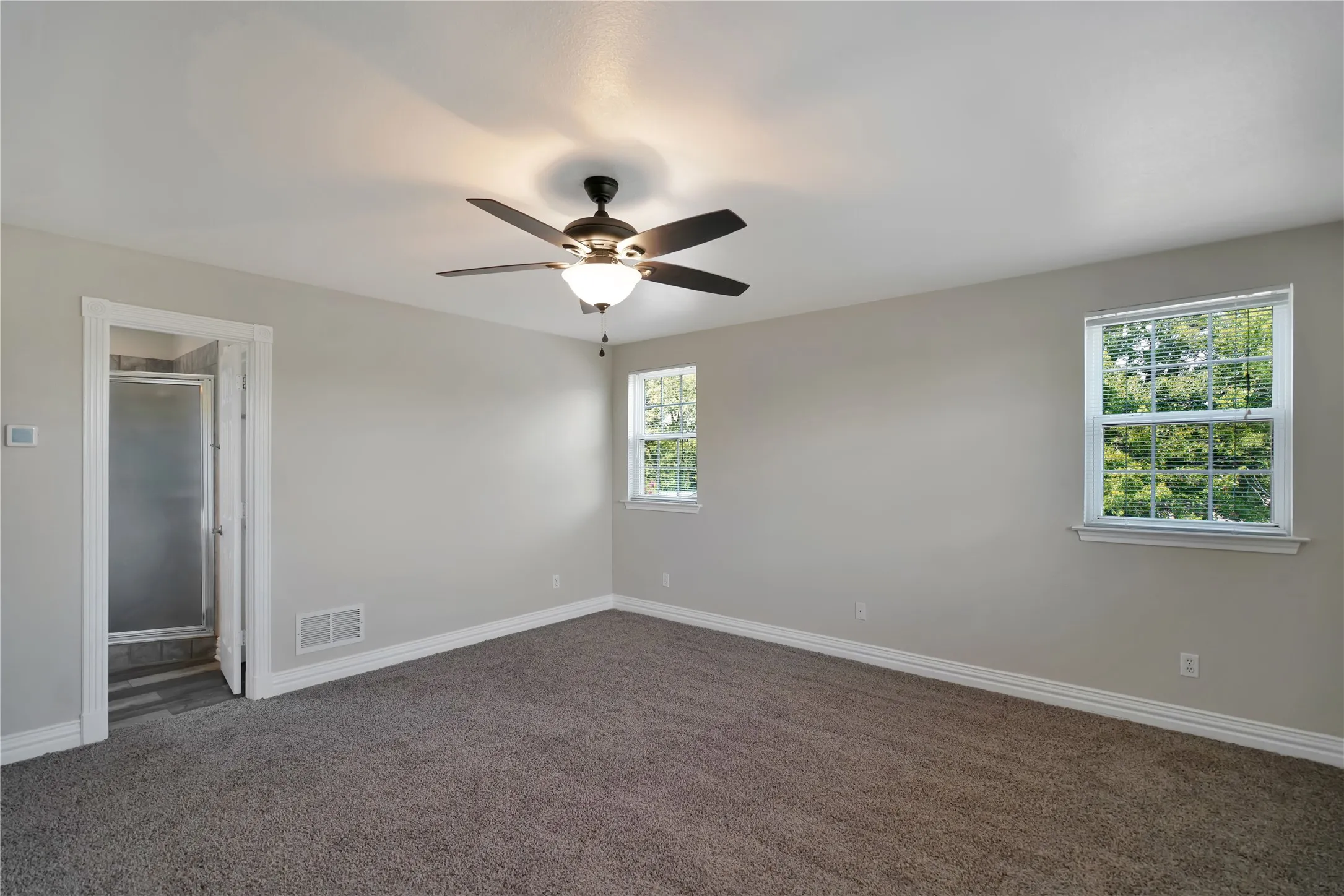 Carpeted flooring throughout, recessed lighting, and a ceiling fan with integrated light fixture