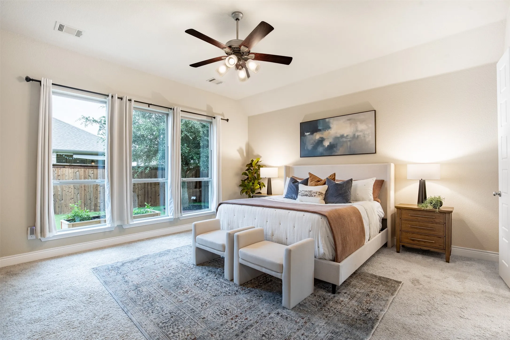 Tray ceiling, recessed lighting, and a ceiling fan with integrated lighting