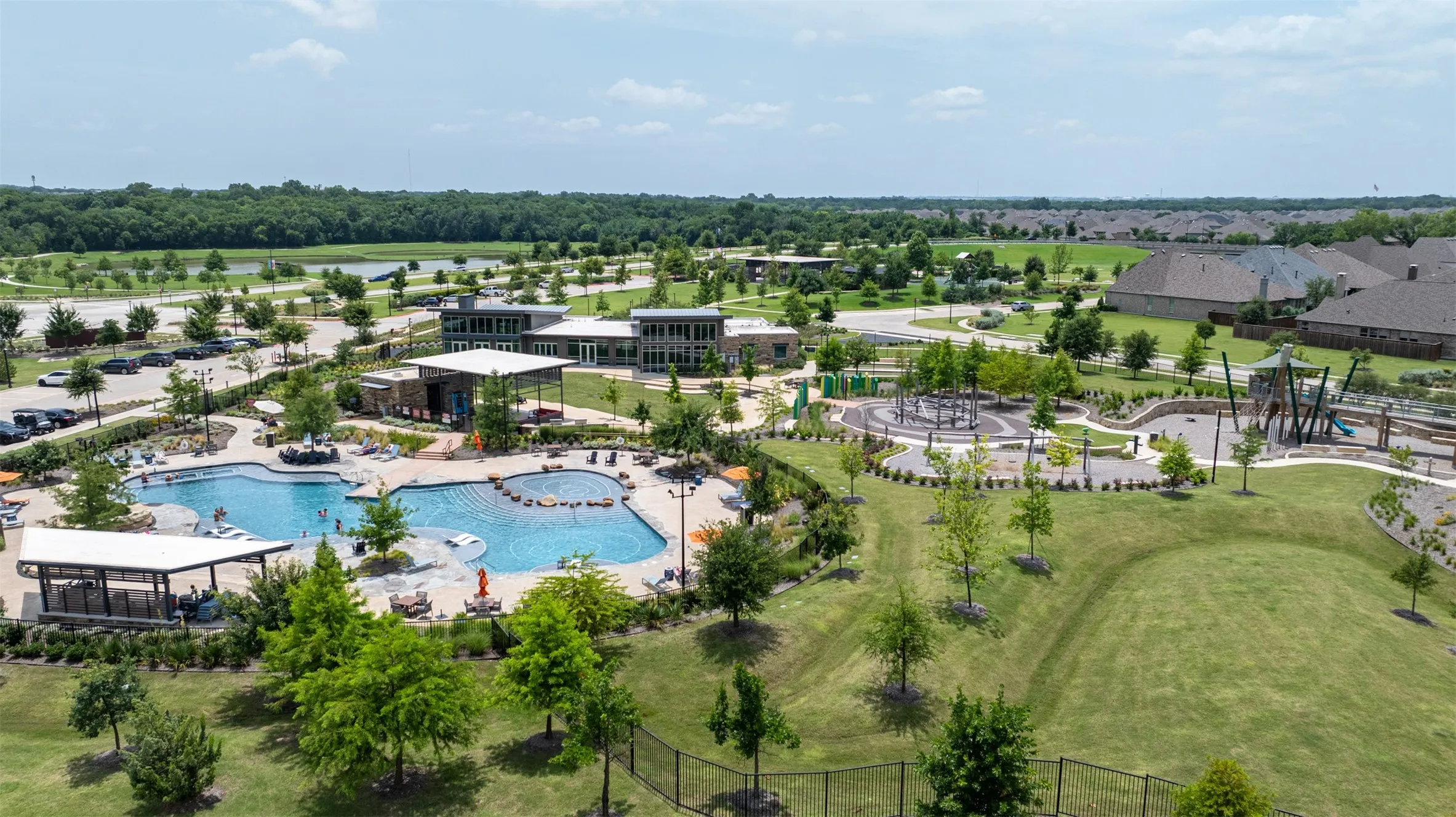 Walk to the resort-style pool with integrated spa, expansive community playground, open green spaces, and contemporary community buildings